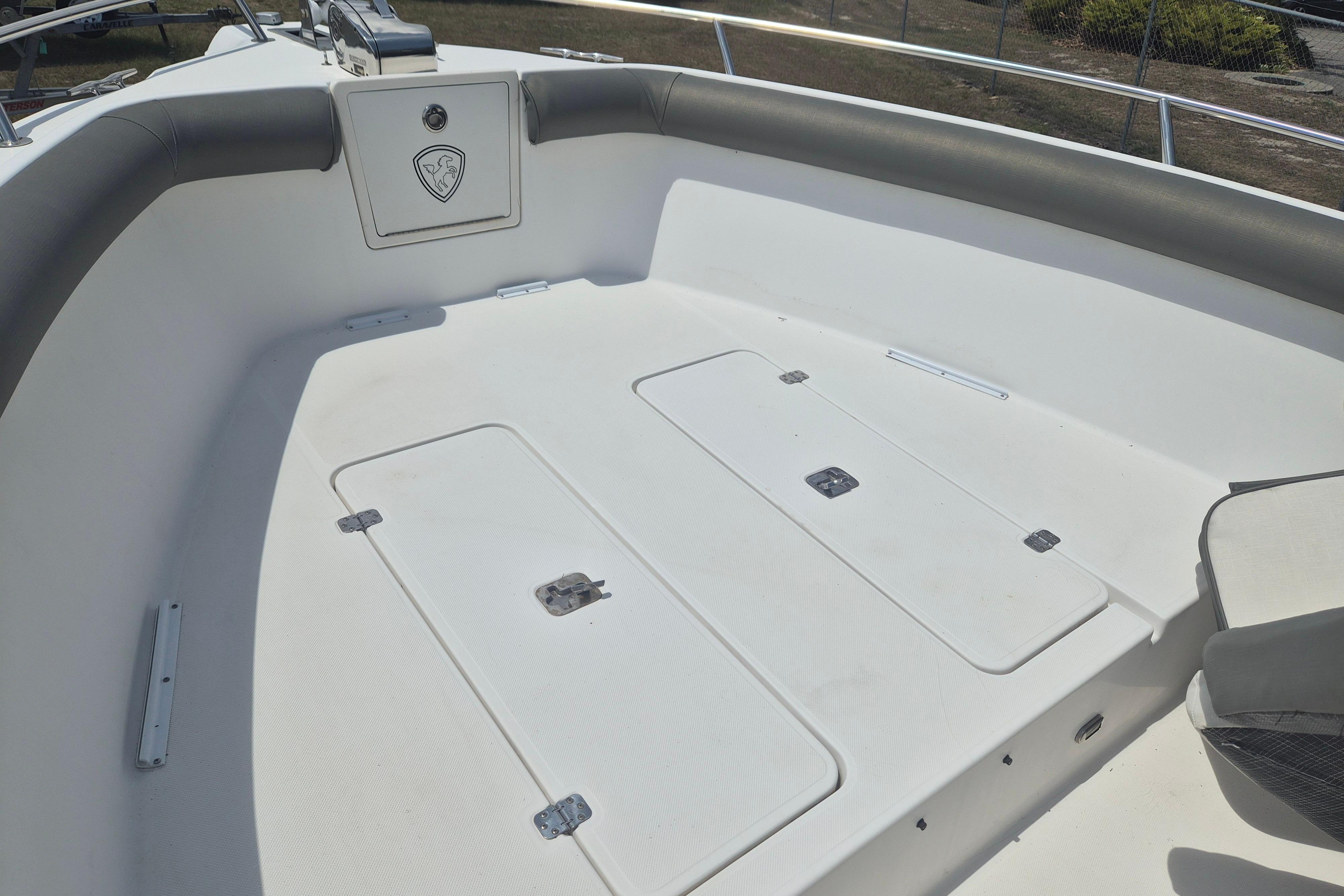 2006 Century 2900 Center Console boat interior with storage compartments and cushioned seating.