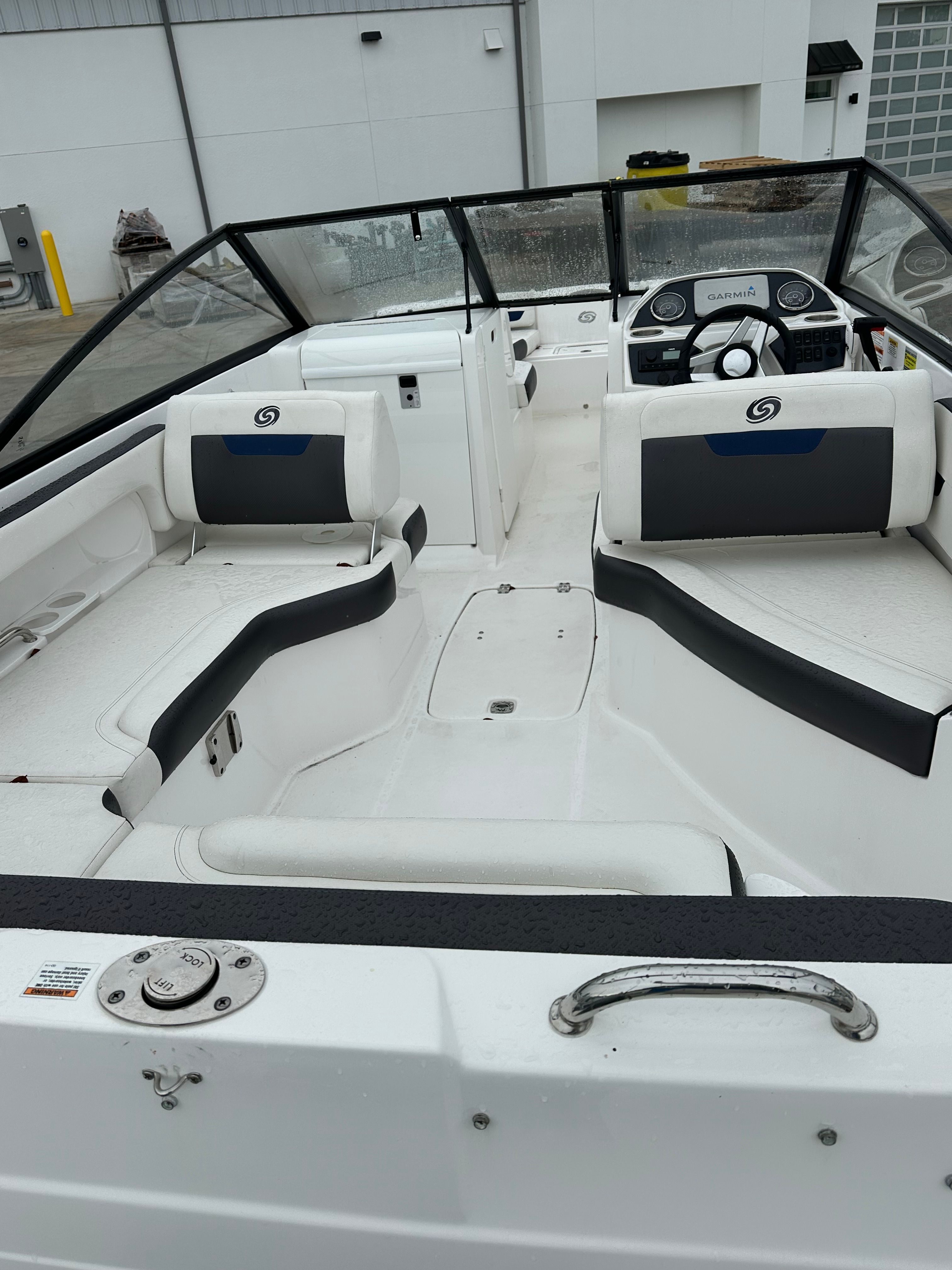 Interior of a 2022 Hurricane 235SD boat with white seating.