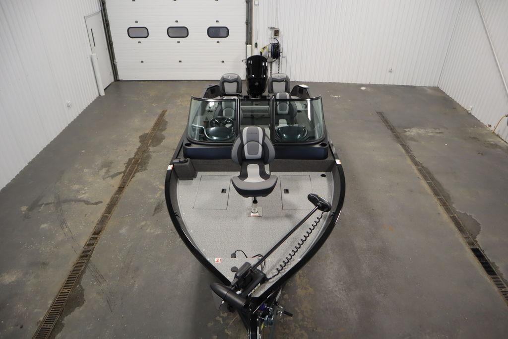 2026 Lowe Fishing Machine 175 in a garage, showcasing seating and controls.