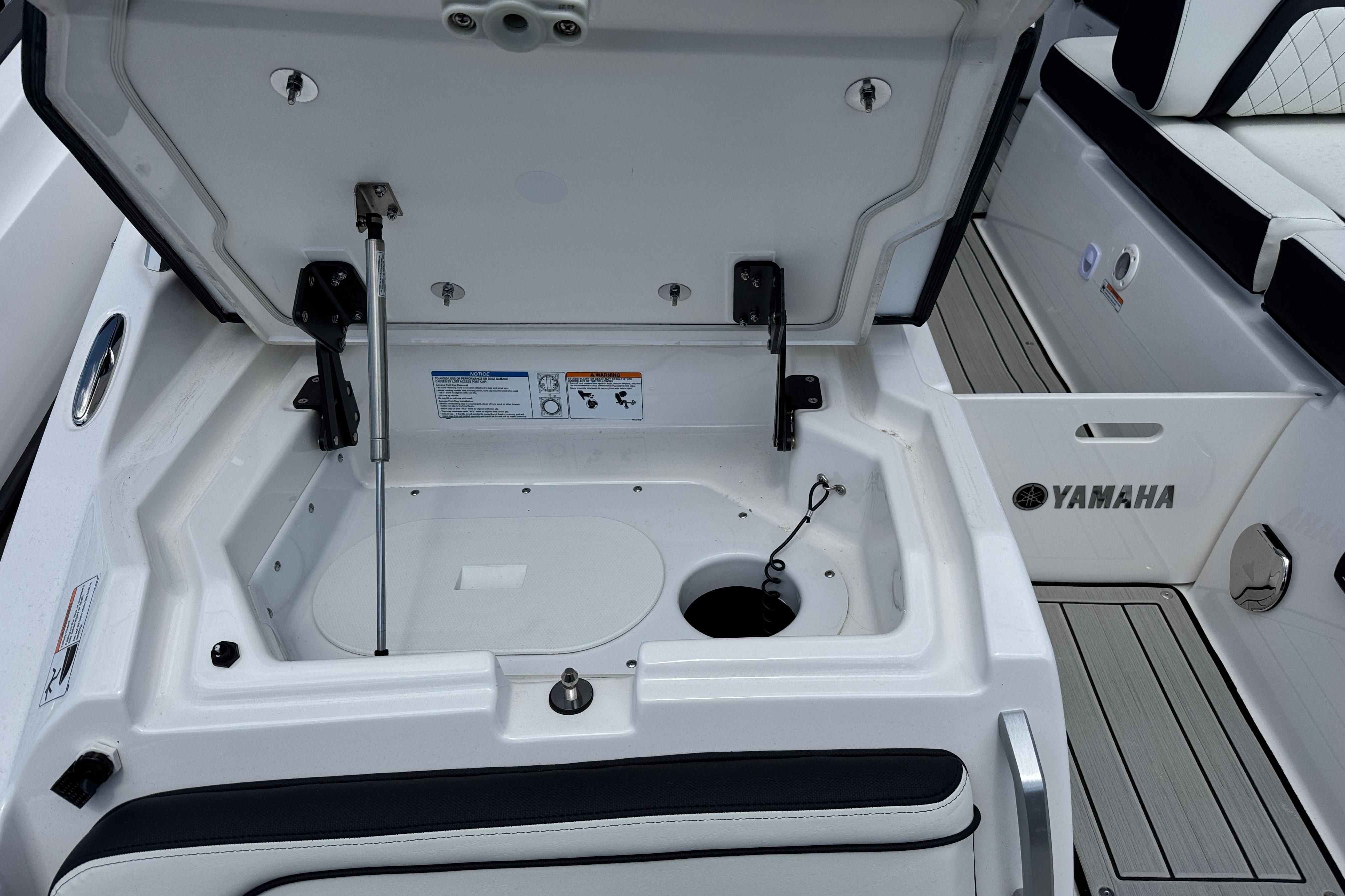 Open storage compartment on 2026 Yamaha Boats 275SD, showcasing interior features and design.