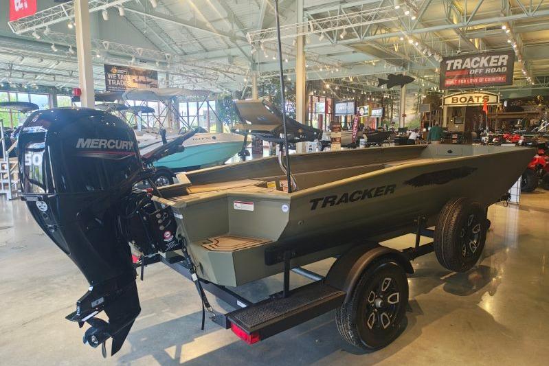 2026 Tracker Grizzly 1650 T Prairie Wings Edition boat displayed in showroom.