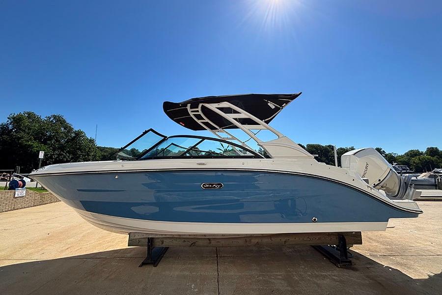 2027 Sea Ray SDX 230 Outboard boat on display under clear blue sky.