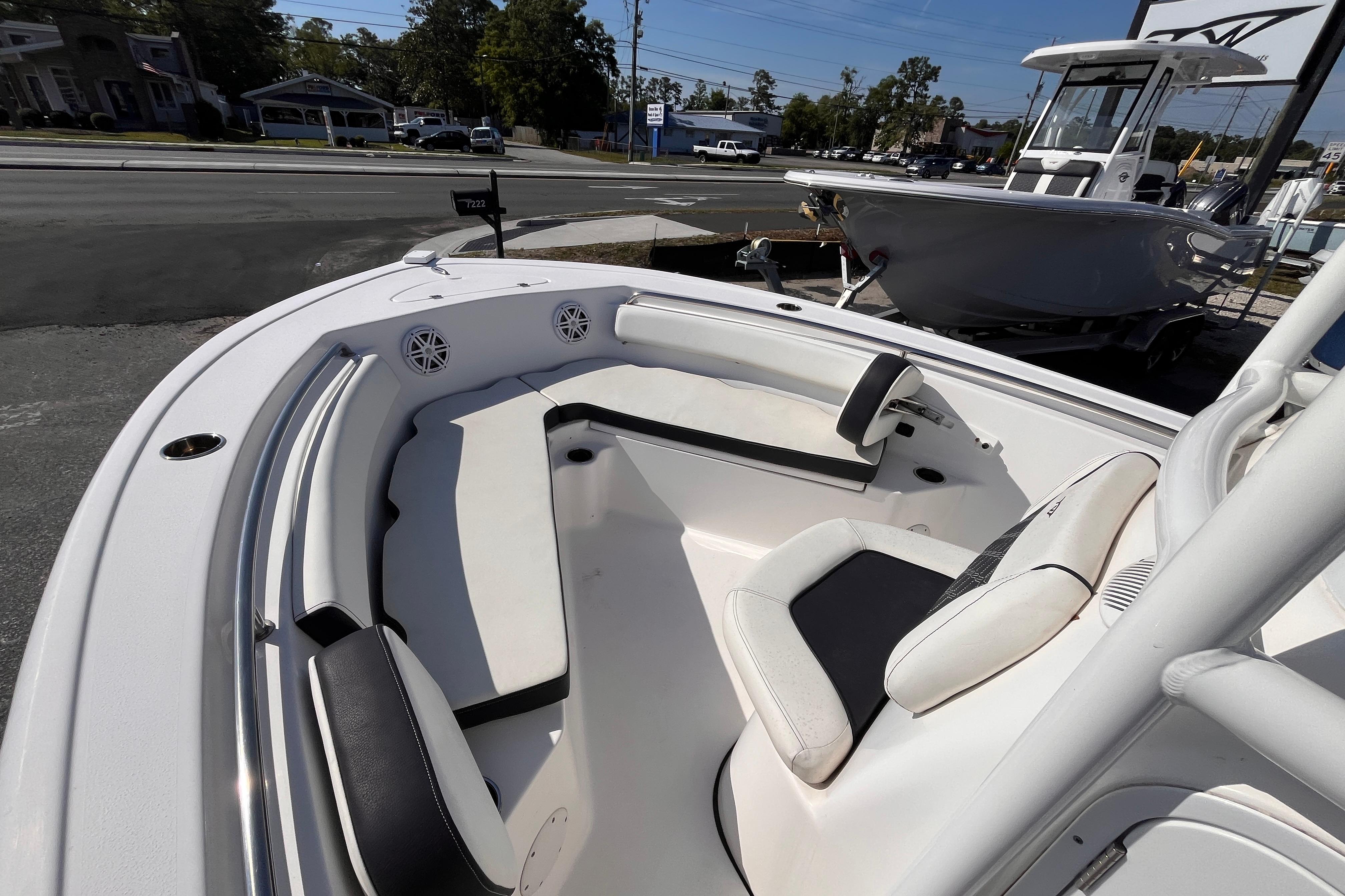 2022 Tidewater 210 LXF boat interior with seating and speakers, displayed outdoors.