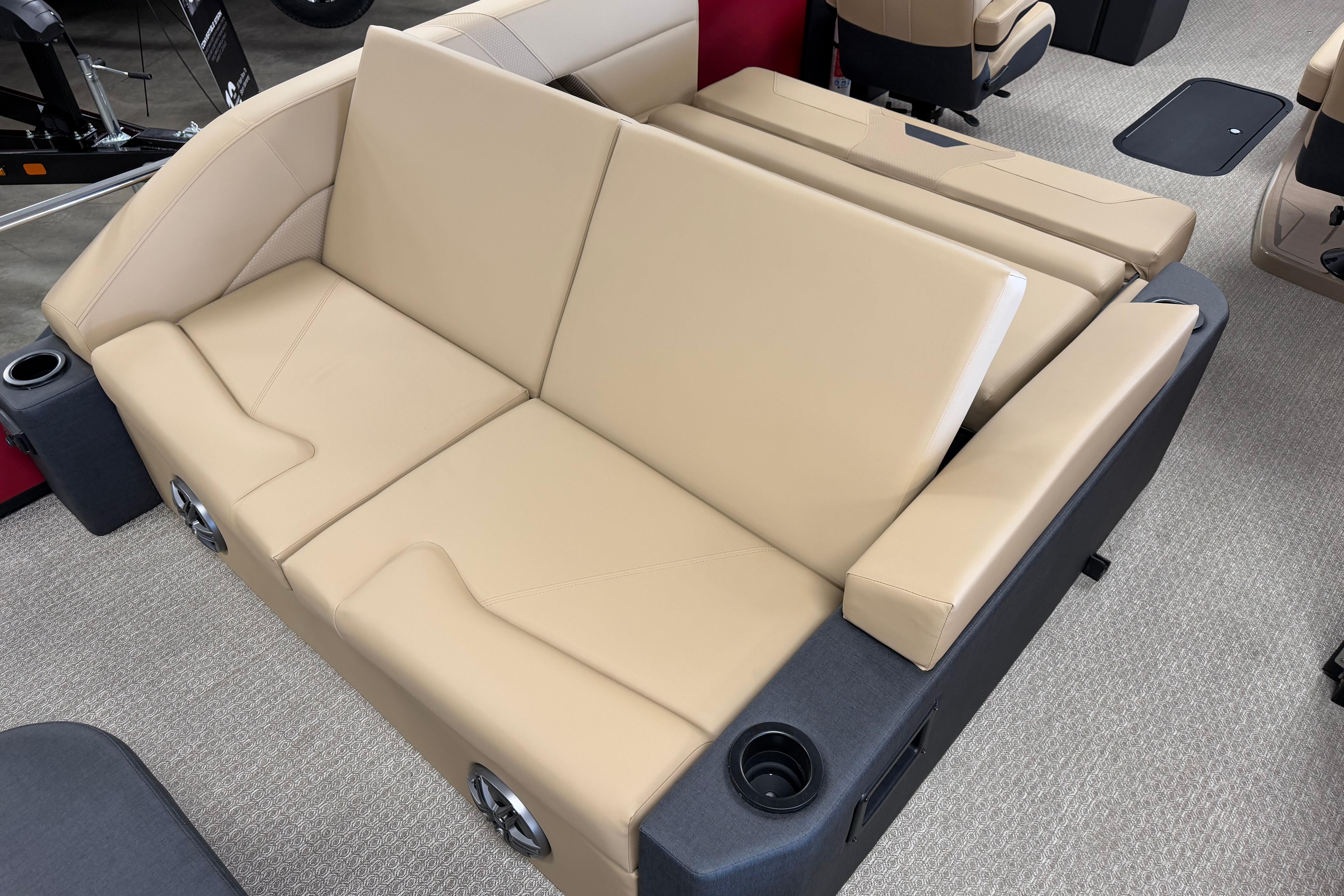 Luxurious beige seating in 2026 Evotti 523CS boat, featuring cup holders and modern design.