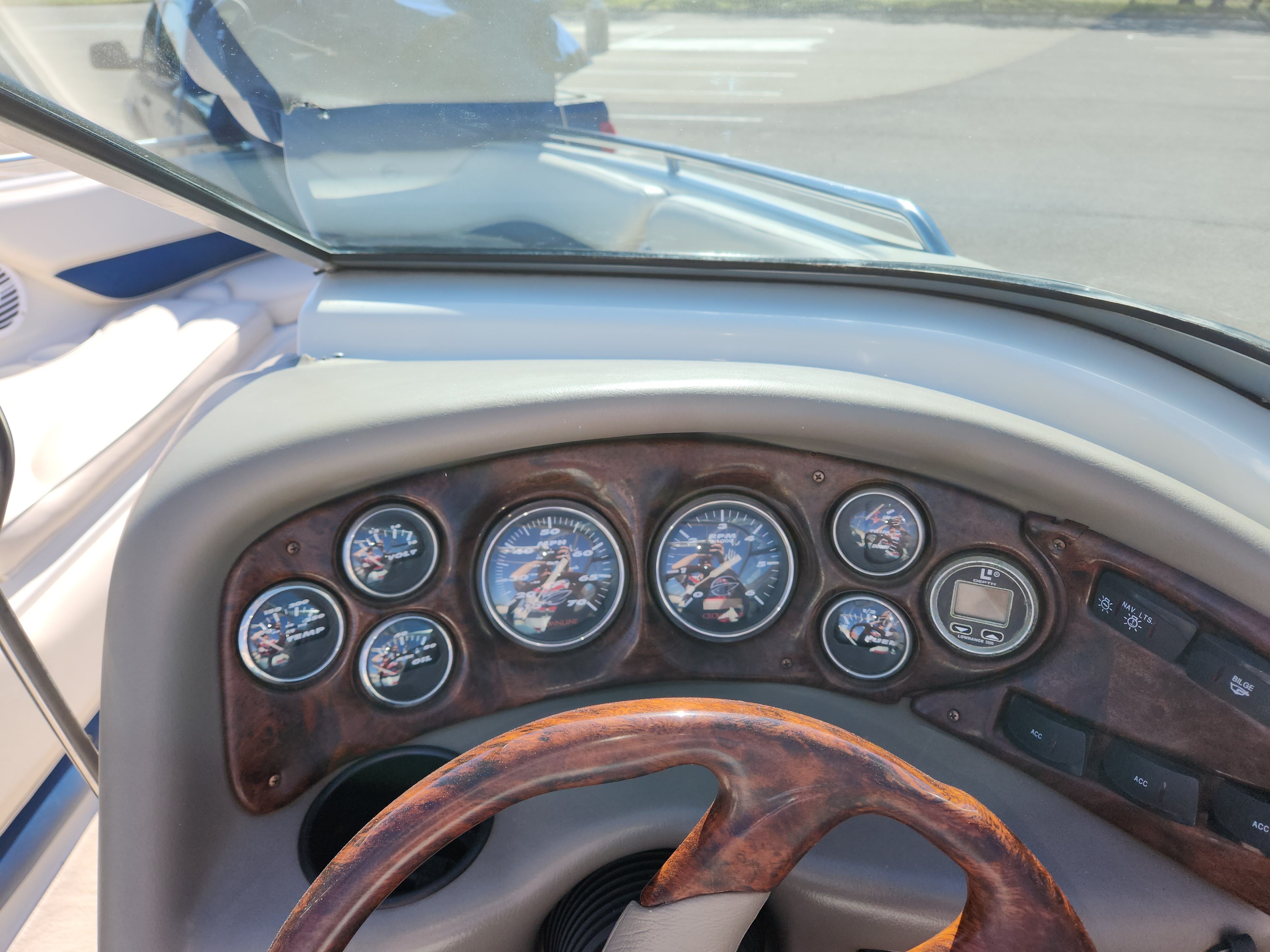 Dashboard of a 2003 Crownline 225 BR boat with wood accents.