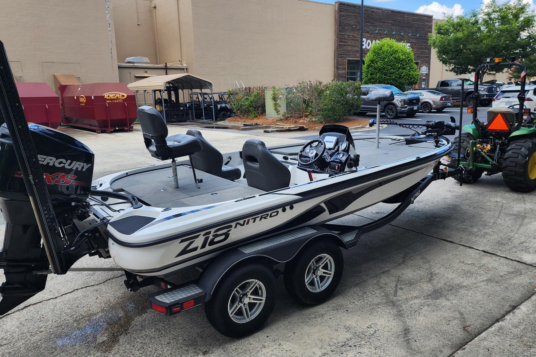 2017 Nitro Z18 boat on trailer, parked outdoors near industrial buildings.