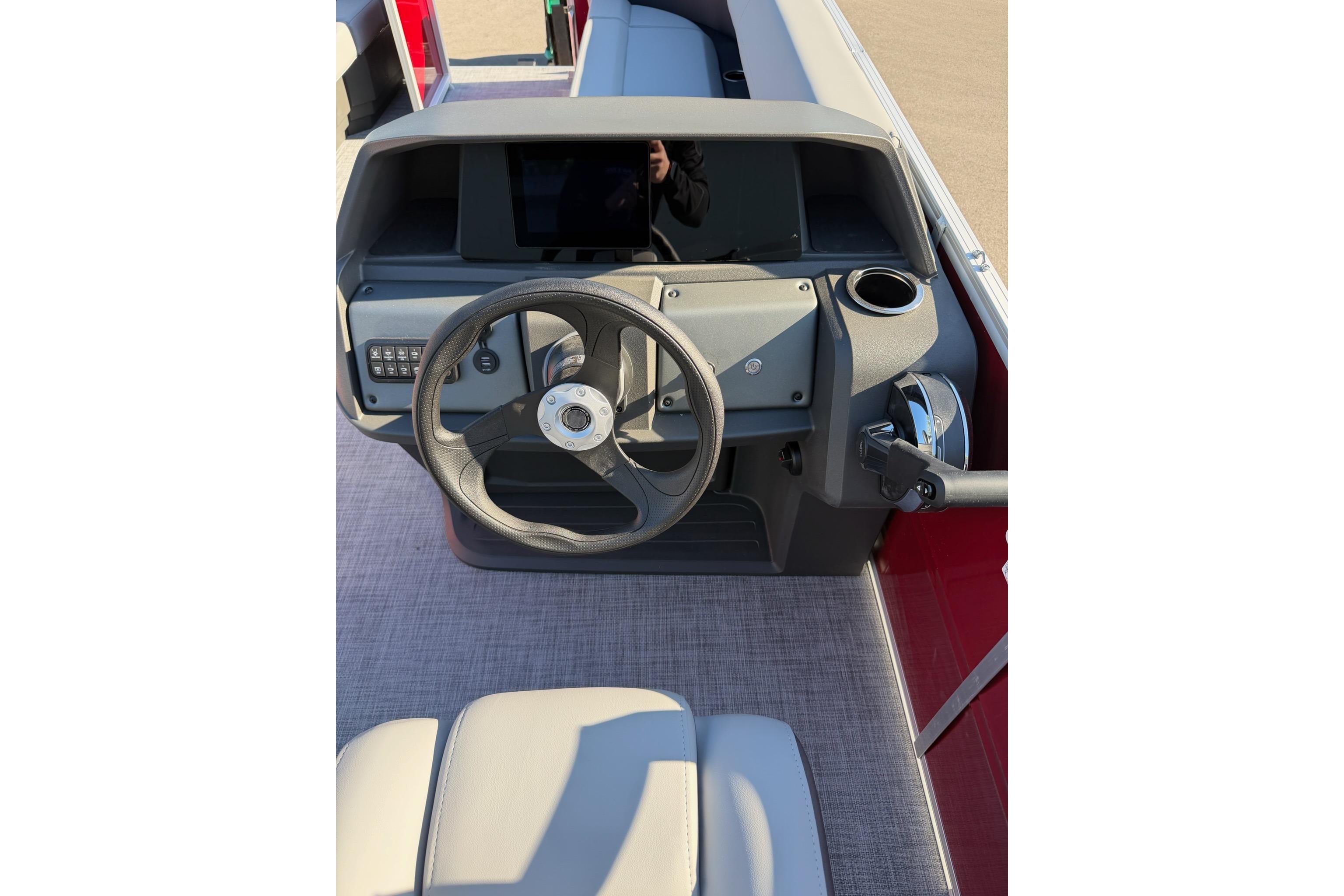 2026 Sun Tracker Party Barge 18 DLX steering console with modern controls and cup holder.