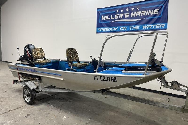 2006 SCANDY WHITE 1310 boat on trailer at Miller's Marine showroom.
