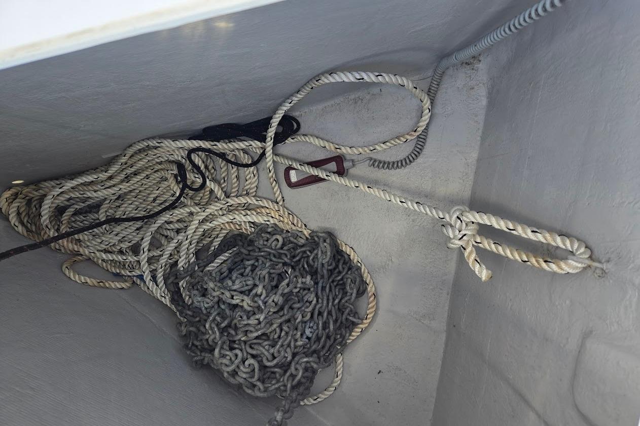 Ropes and chains in the anchor locker of a 2023 Beneteau Oceanis 38.1 sailboat.