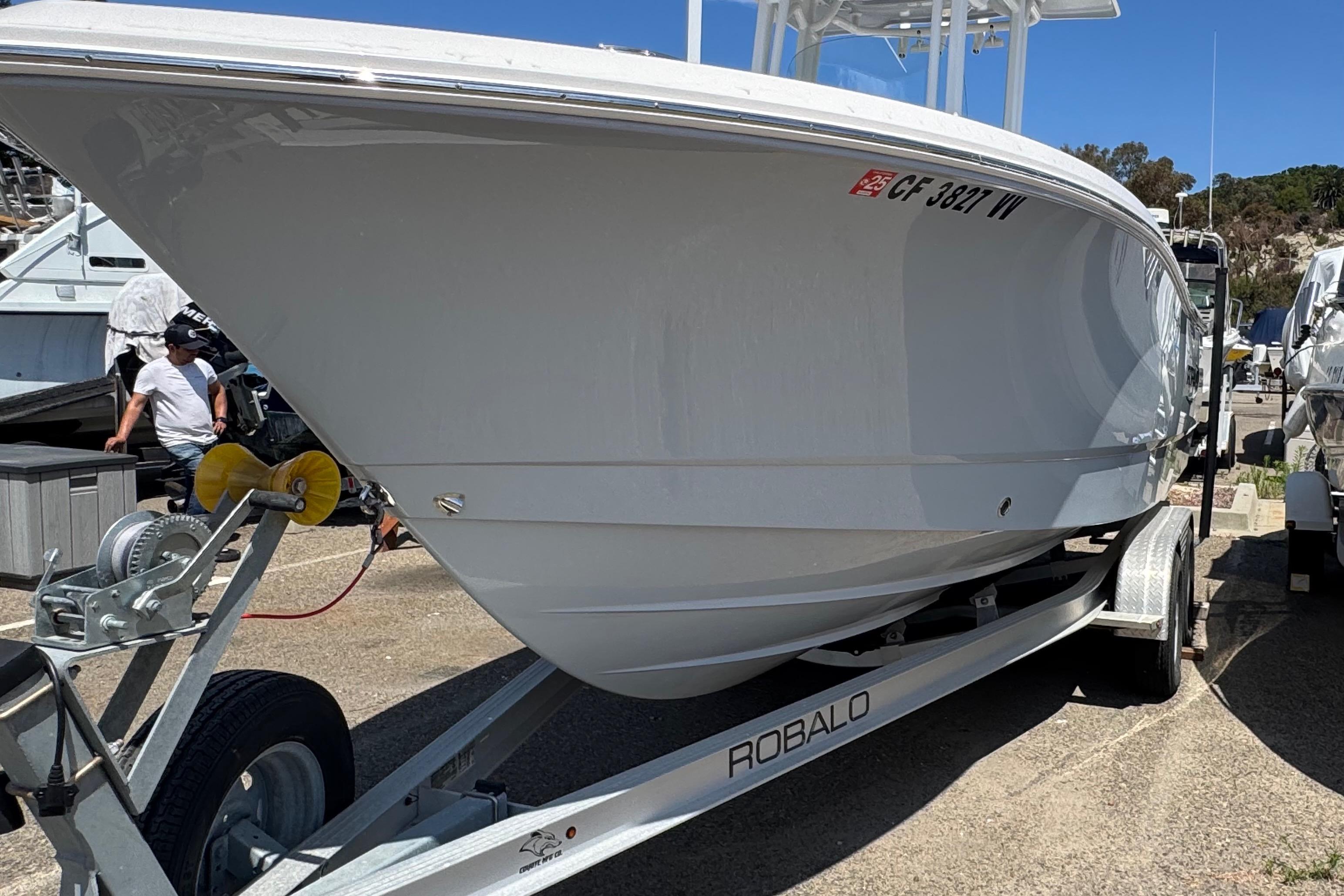 2022 Robalo R230 Center Console boat on trailer, parked outdoors.