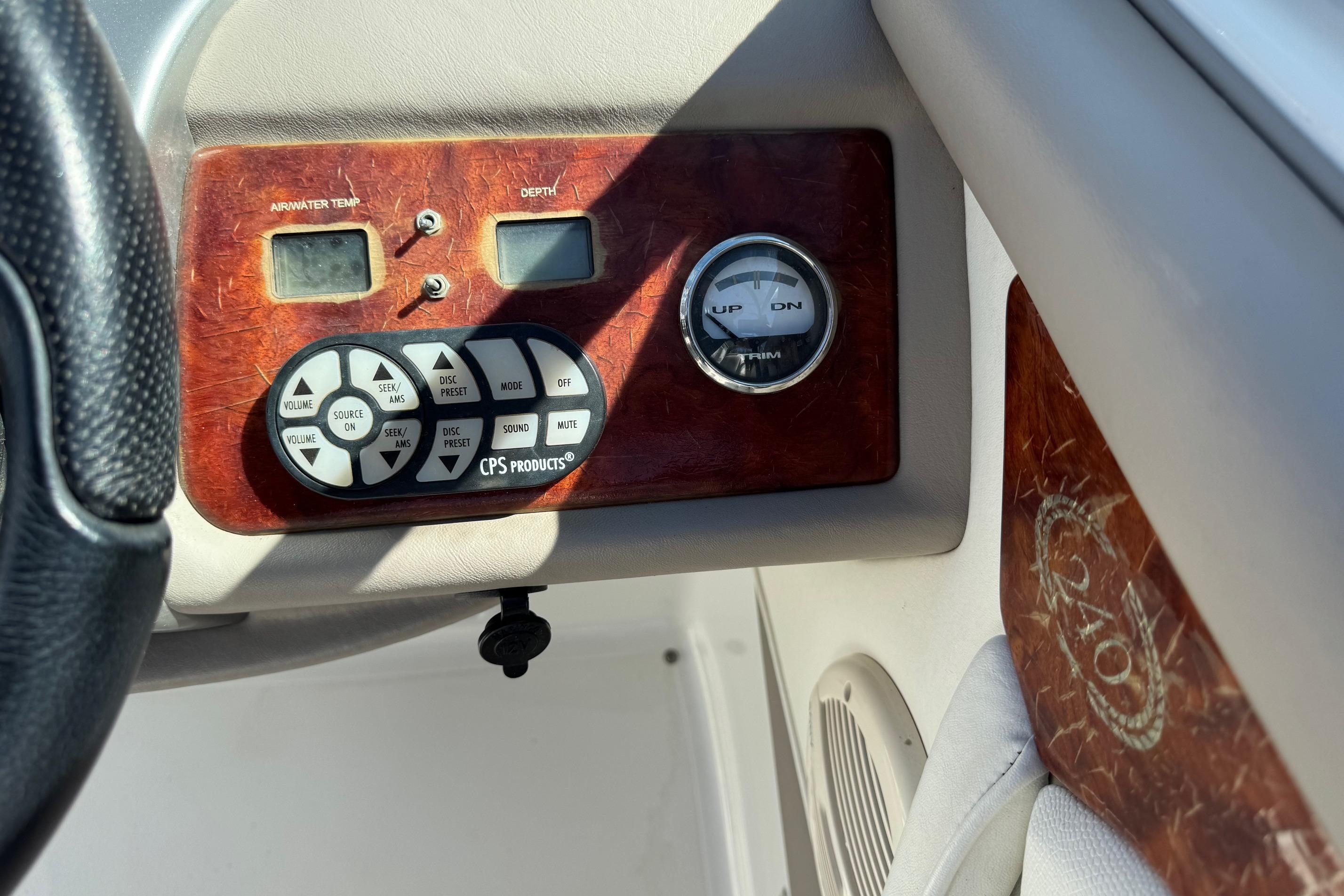 Control panel of a 2005 Cobalt 240 boat with temperature and depth gauges.