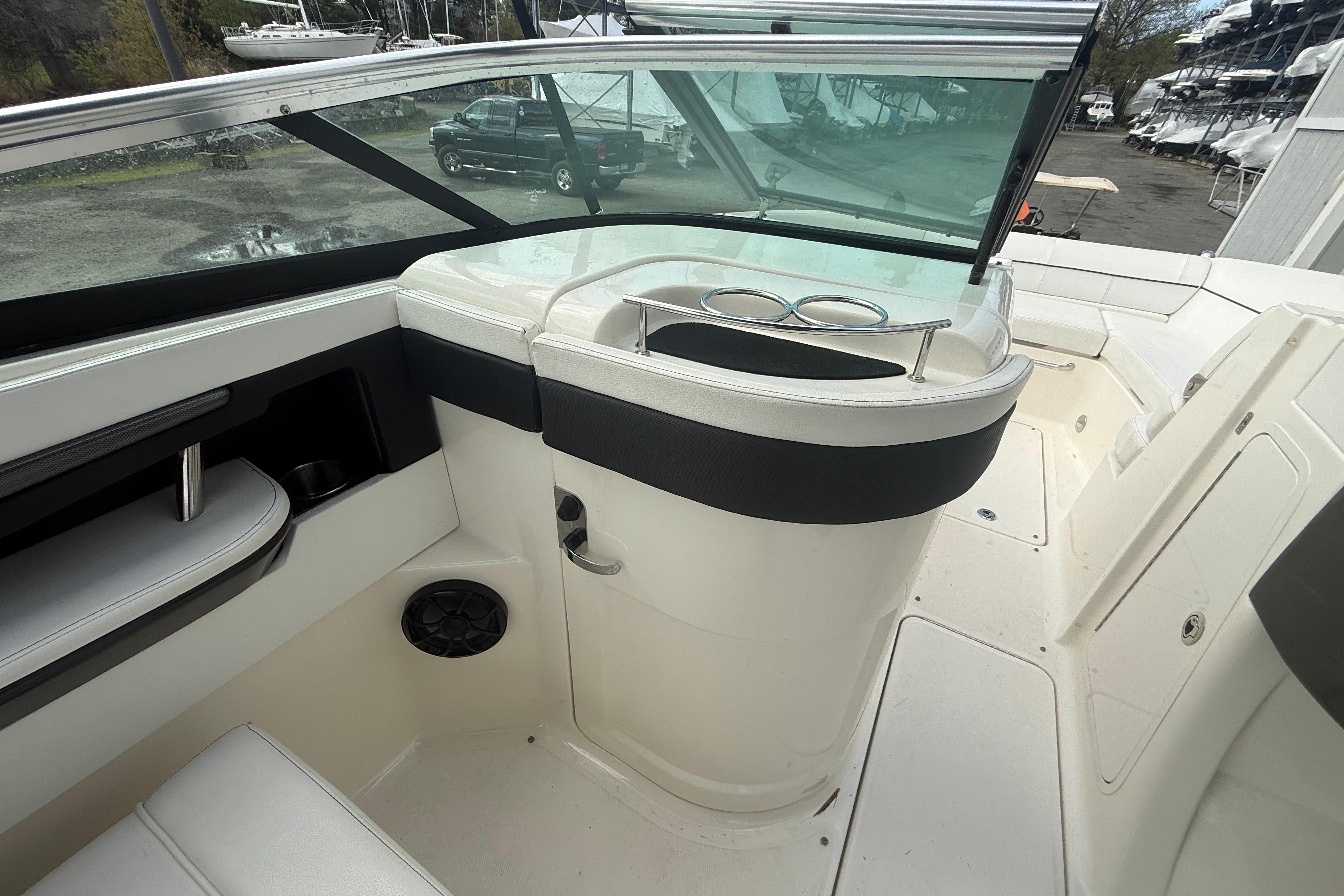 2015 Sea Ray 240 Sundeck interior with seating and cup holders, showcasing sleek design.