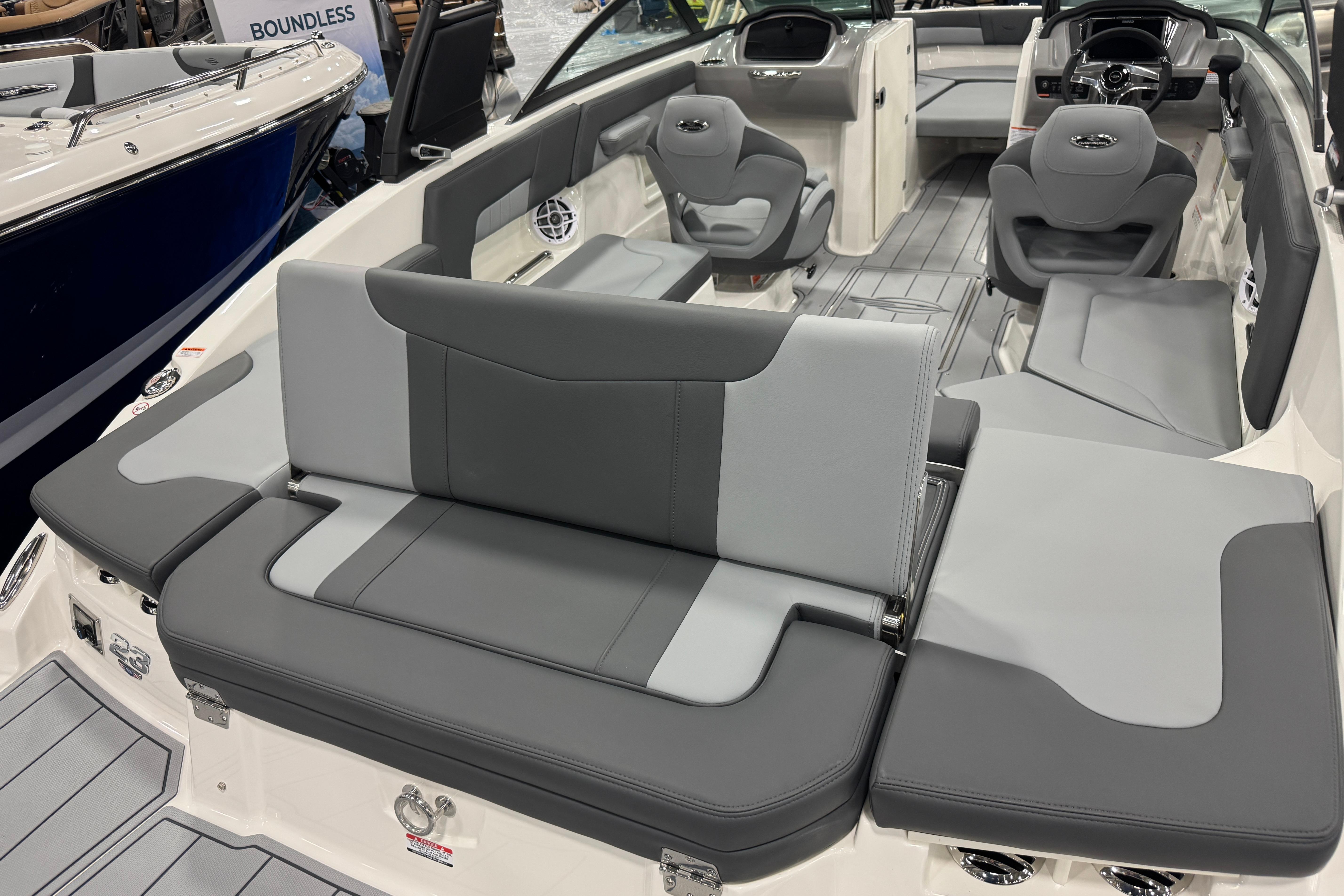 2026 Chaparral 23 SSi boat interior with gray seating and modern dashboard design.