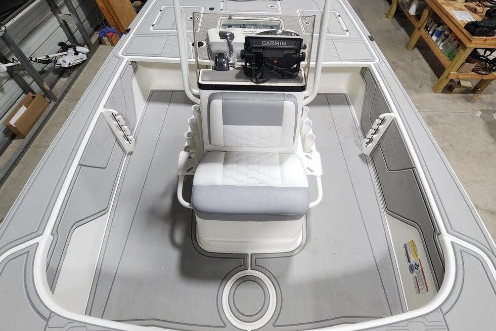 2026 Mako 18 Pro Skiff boat interior with Garmin equipment, featuring sleek seating and storage.