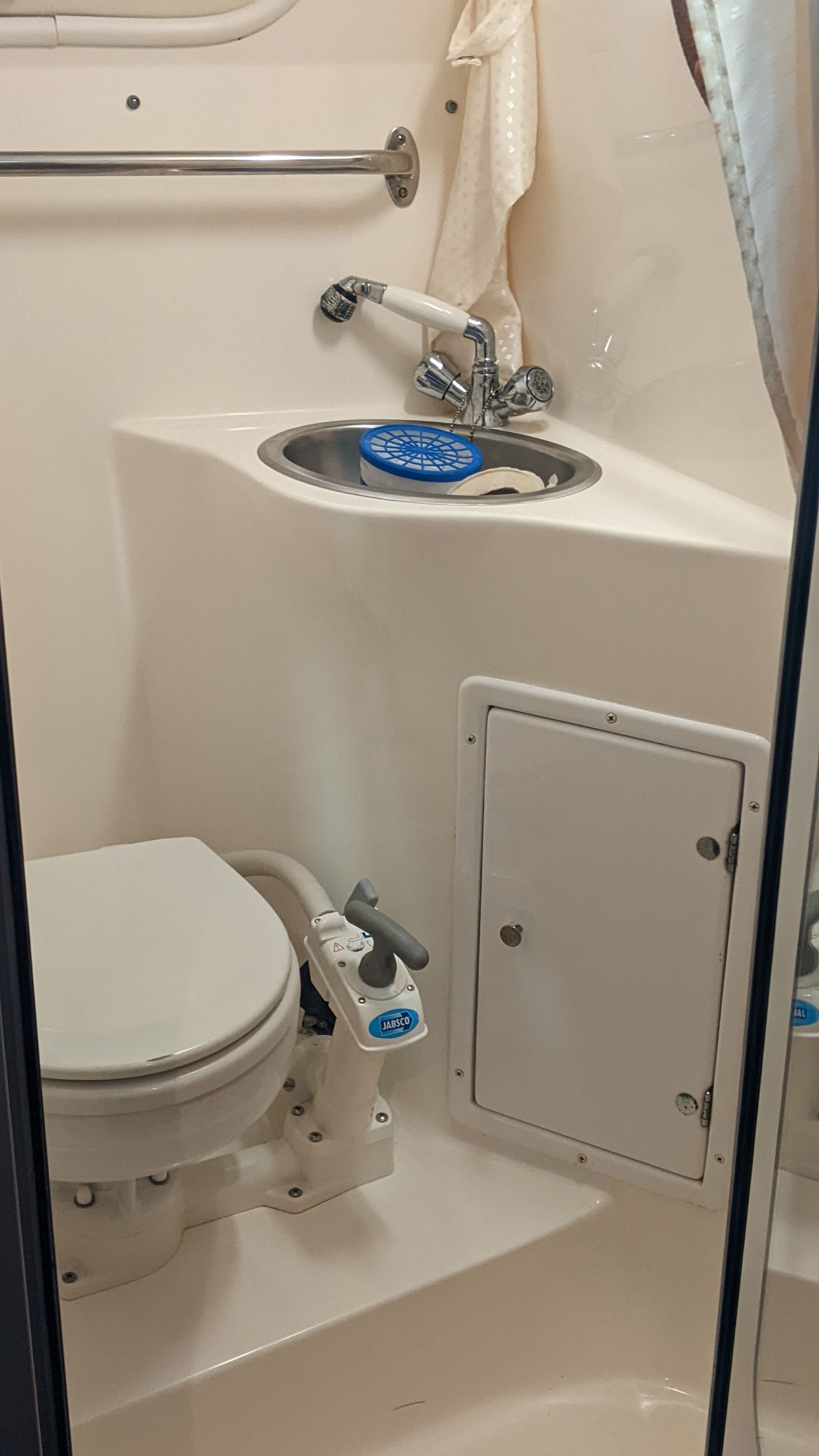 Interior of a 2006 Rinker 250 EC yacht with toilet and sink.