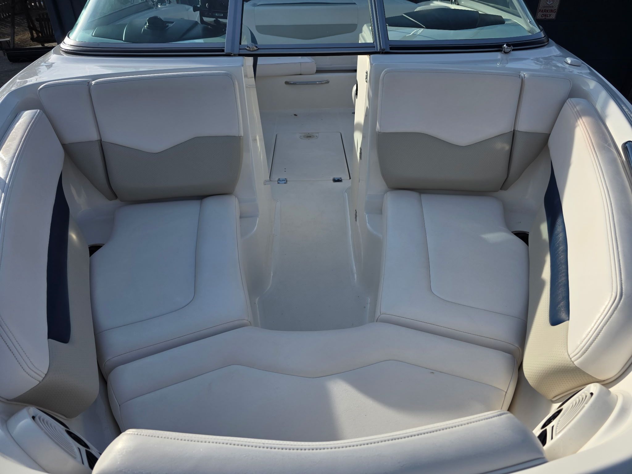 Interior view of a Chaparral 206 SSi boat with white cushioned seats.