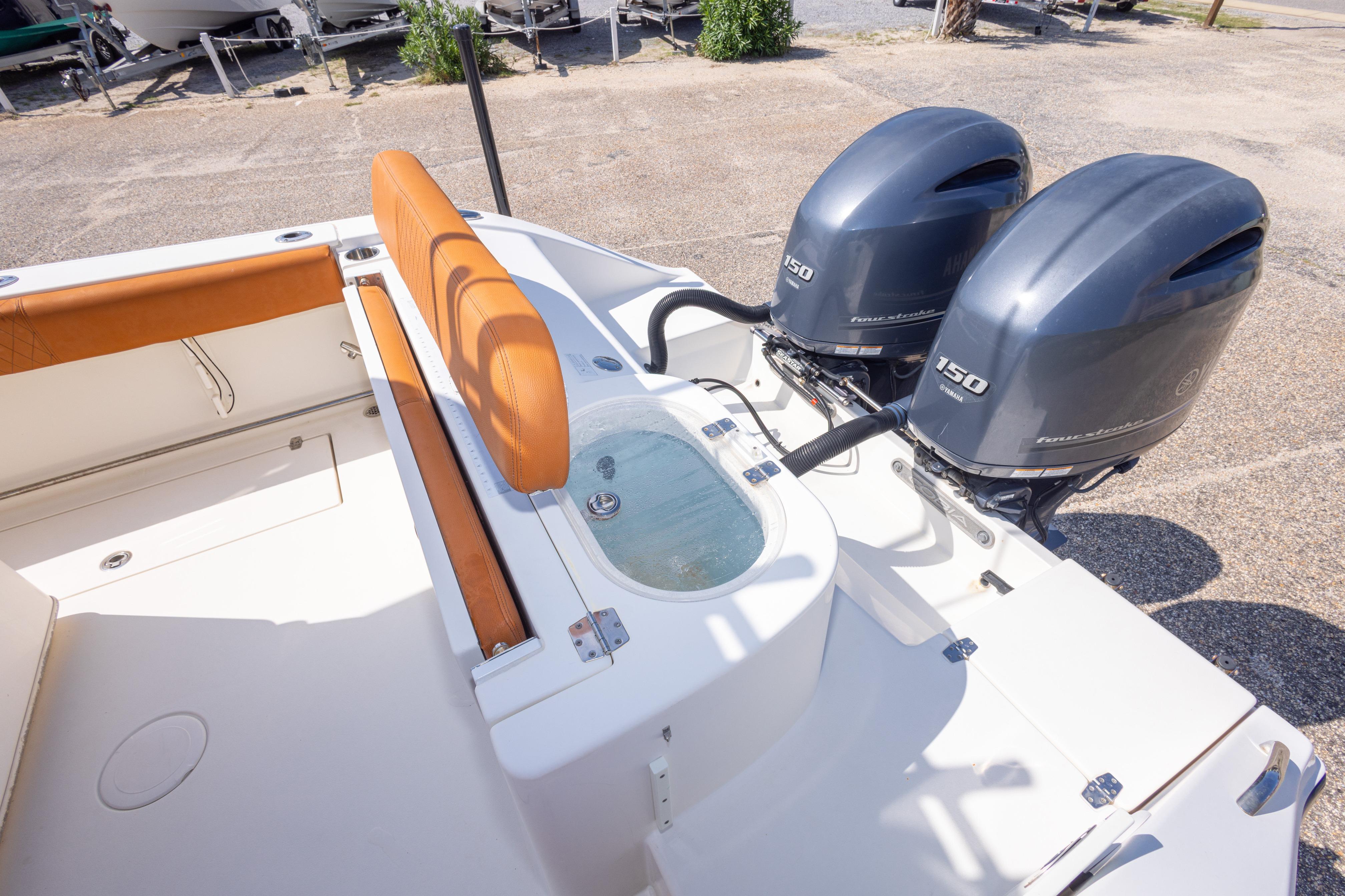 2017 Cobia 261 Center Console boat with twin 150 horsepower engines and seating area.