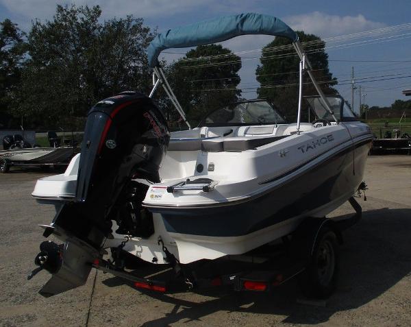 2023 Tahoe 185 S boat with outboard motor on trailer, parked outdoors.