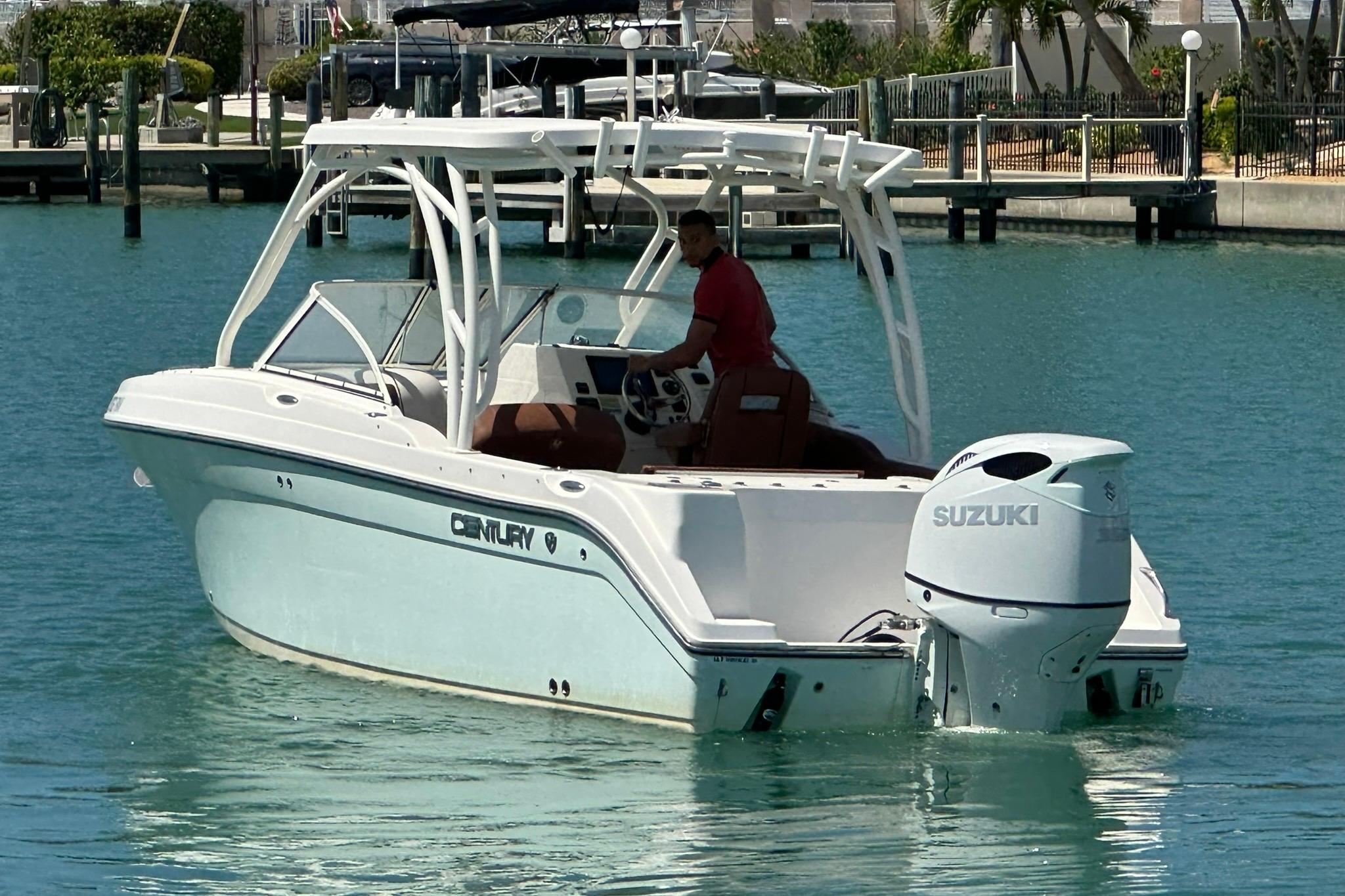 2019 Century 24 Resorter boat with Suzuki engine on turquoise water.