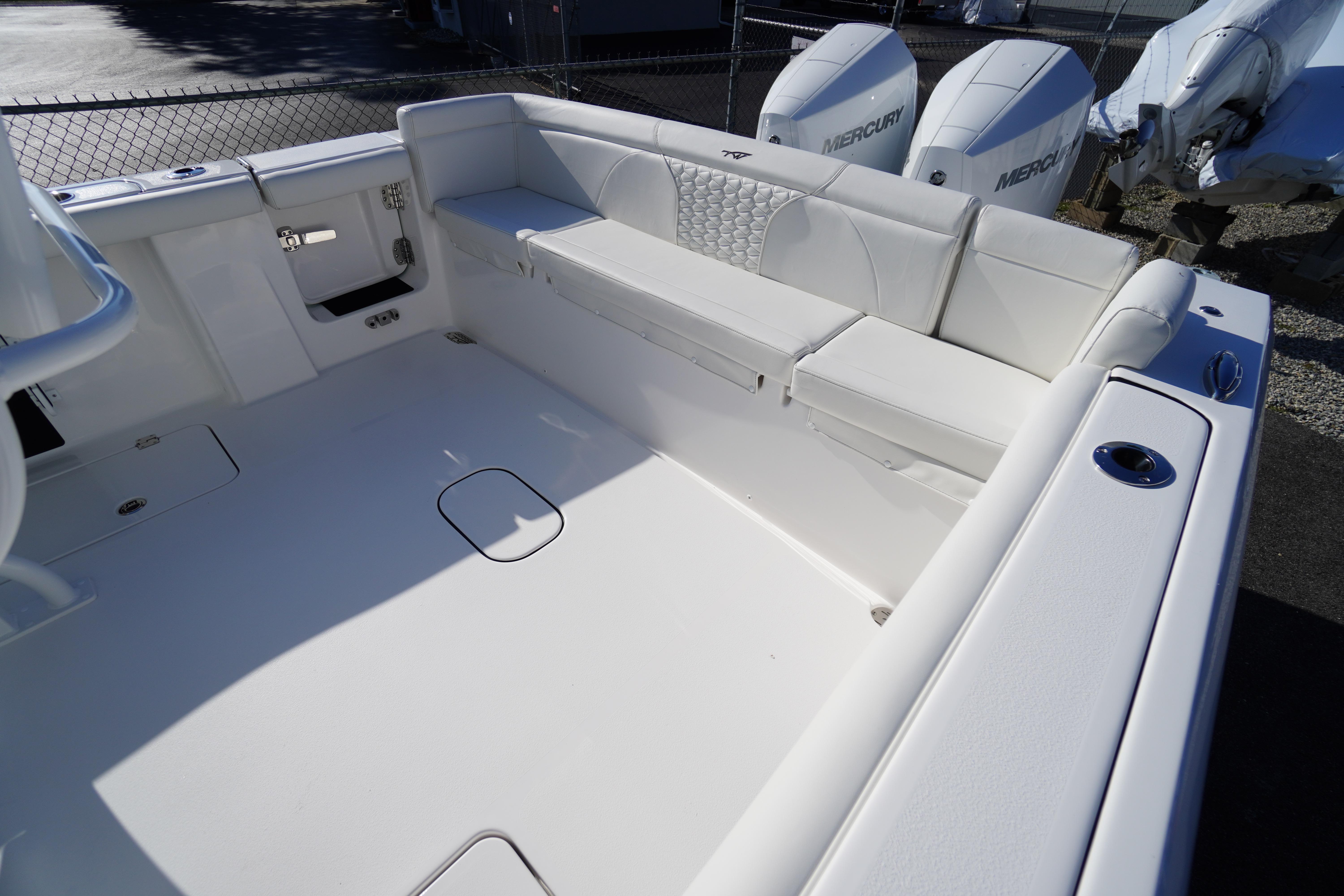 2026 Tidewater 272 LXF boat interior with white seating and dual Mercury engines.