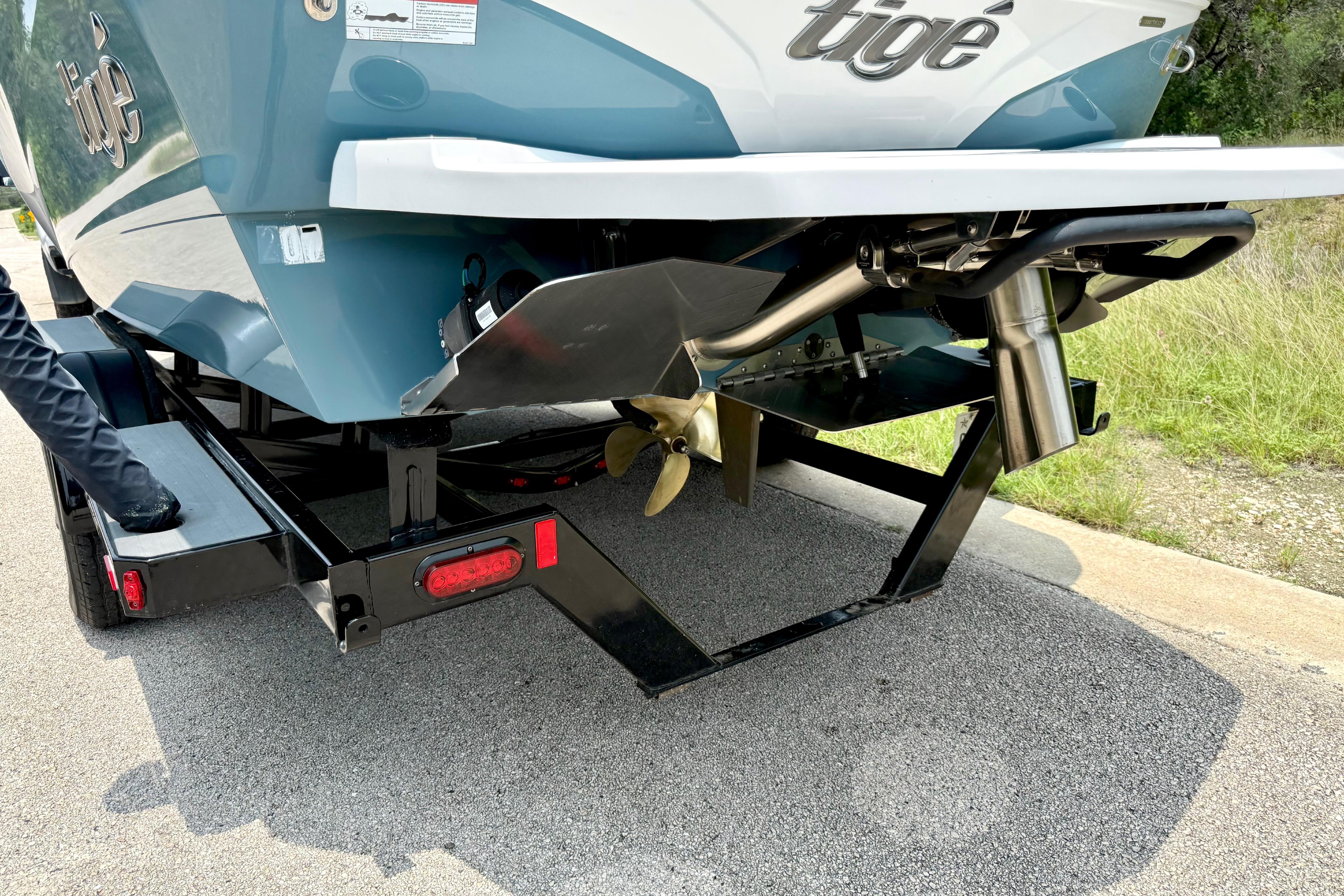 2021 Tige Z3 boat rear view showing propeller and exhaust system on trailer.