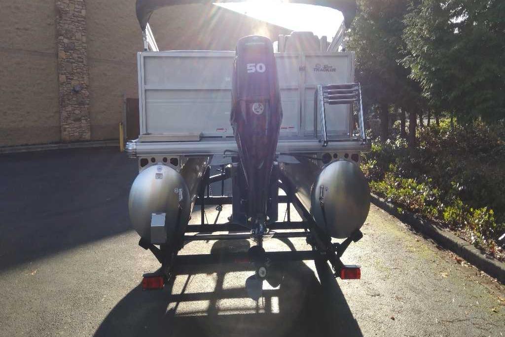2026 Sun Tracker Party Barge 16 DLX pontoon boat rear view with outboard motor.