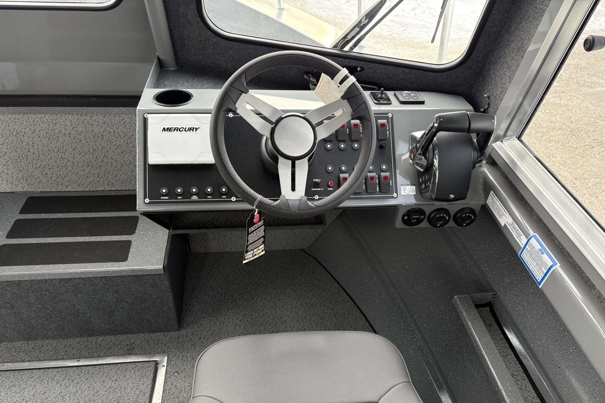 2024 Spartan 26 Maximus Pro XL boat cockpit with Mercury controls and steering wheel.