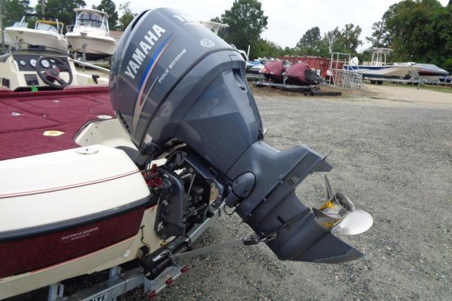 1996 Quantum 180 XD boat with Yamaha outboard motor in a marina setting.
