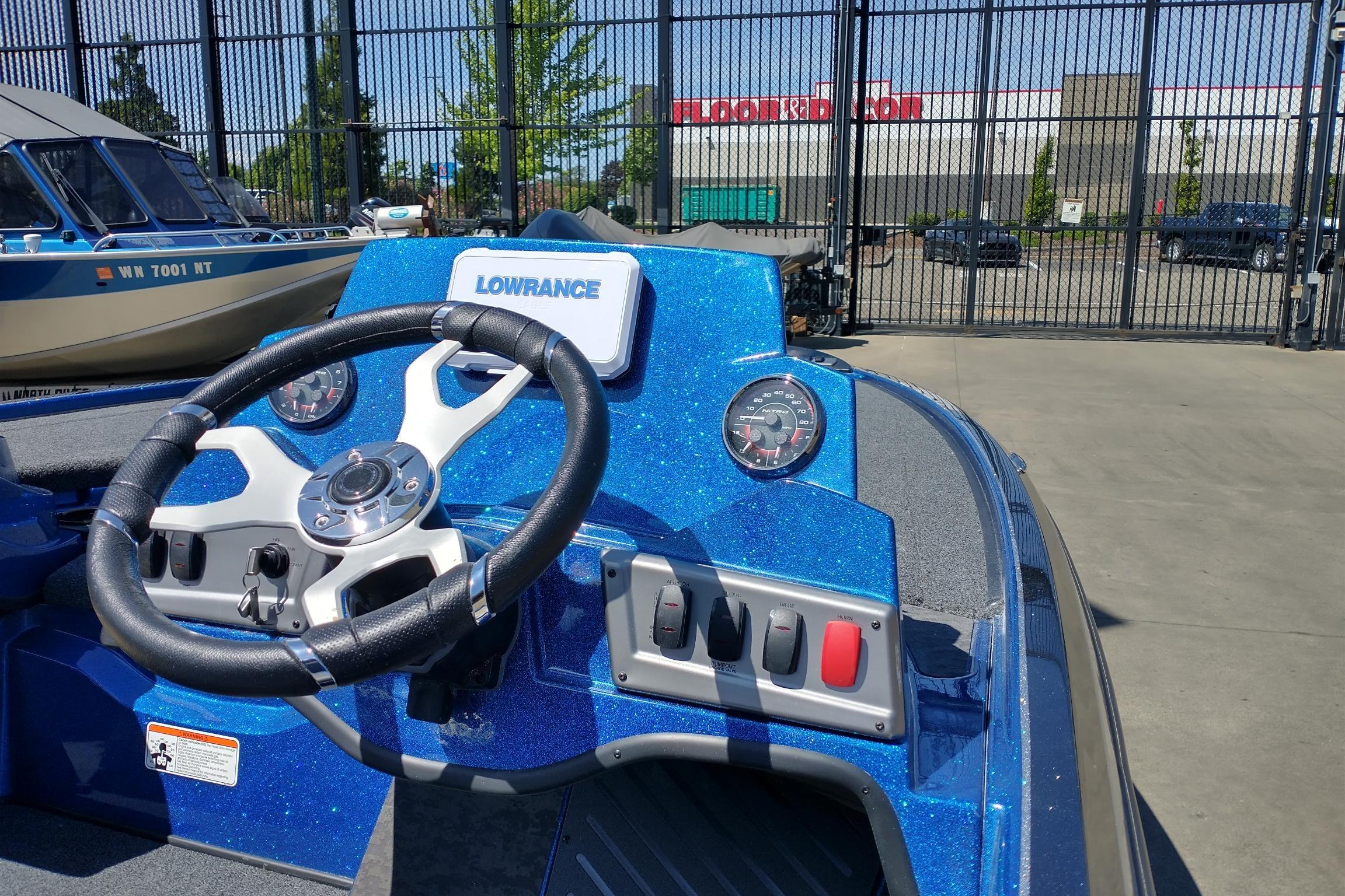 2026 Nitro Z19 XL boat dashboard with steering wheel and Lowrance display.