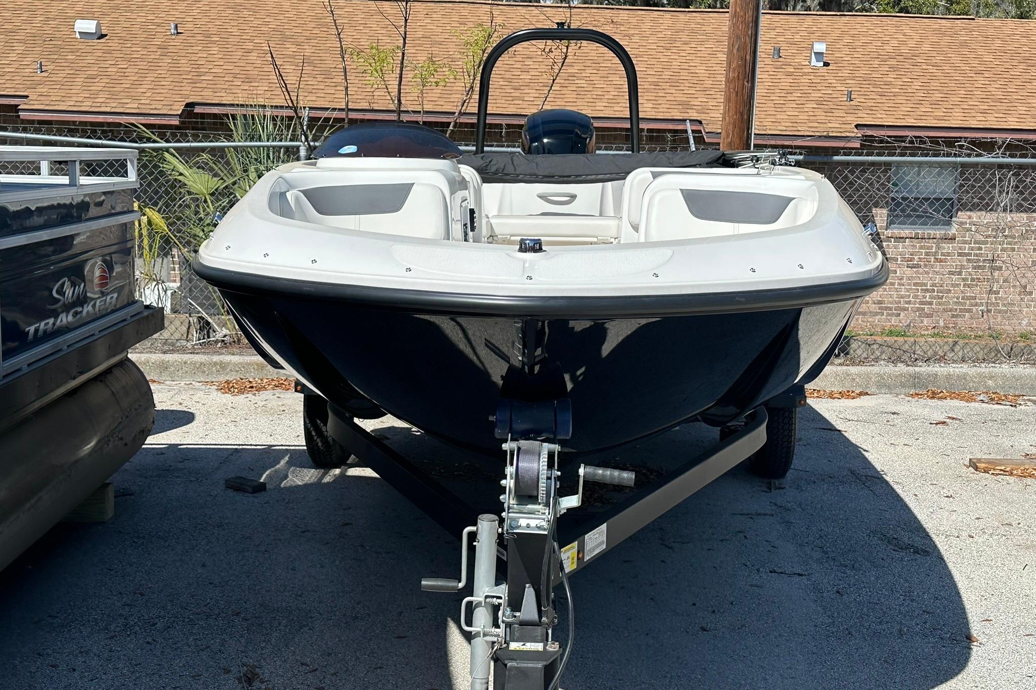 2026 Bayliner Element E18 boat on trailer, parked outdoors.
