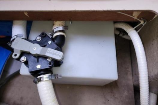 1985 Wasque Down East Cruiser plumbing system with hoses and valve connections.