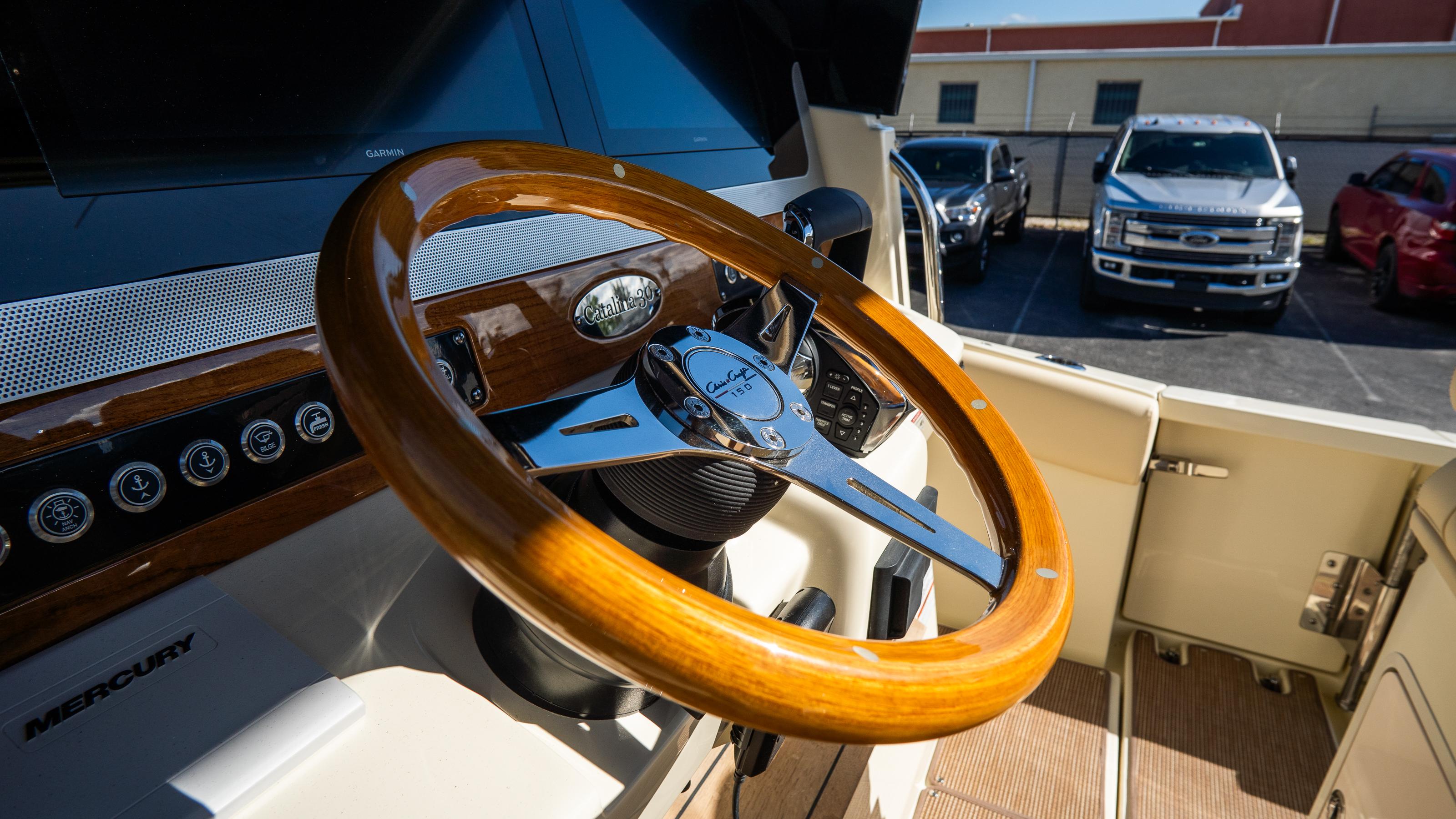 2025 Chris-Craft Catalina 30 steering wheel, featuring elegant wood and chrome design.