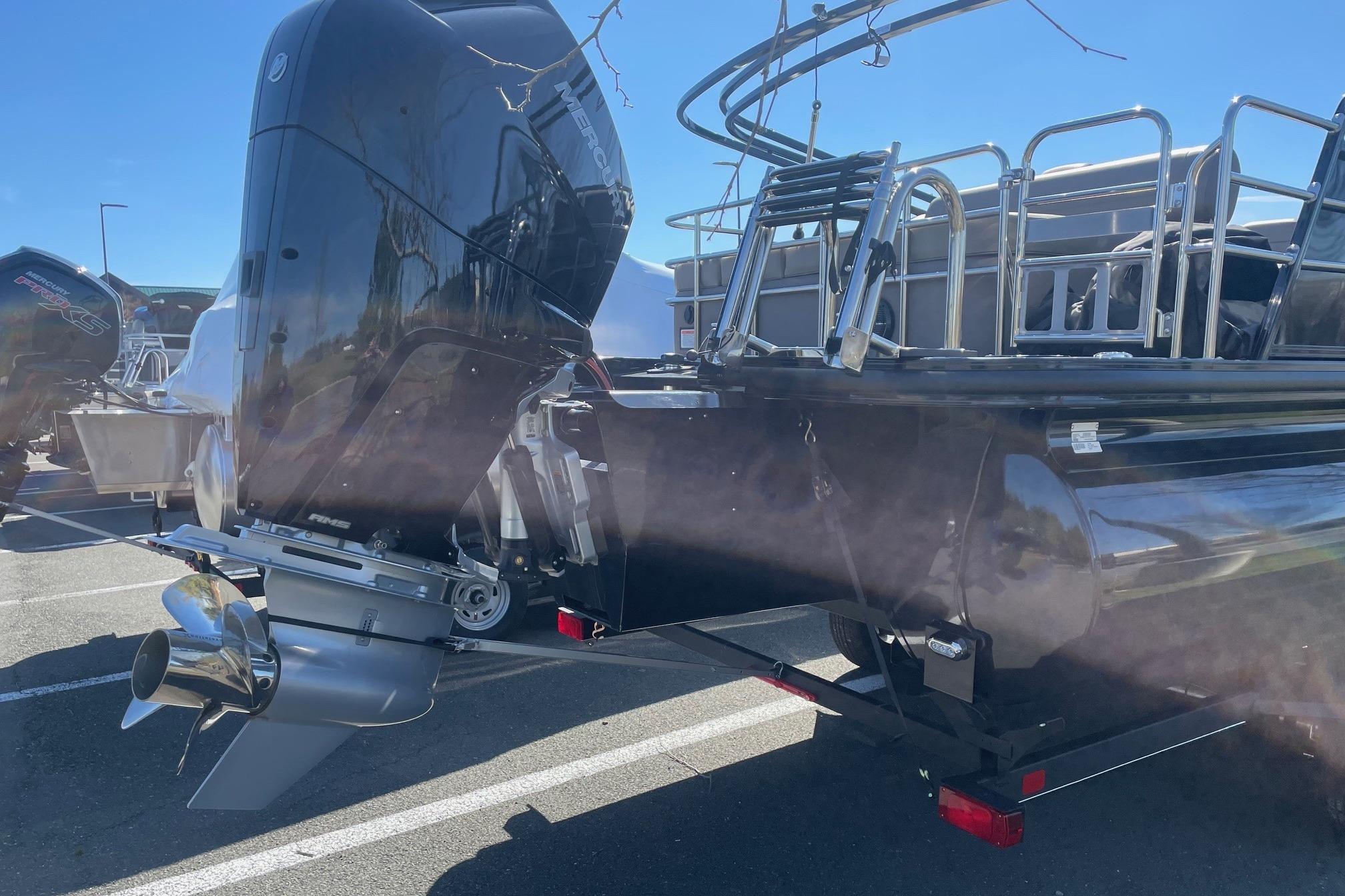 2024 Ranger 2500LS boat with powerful outboard motor in a sunny parking lot.