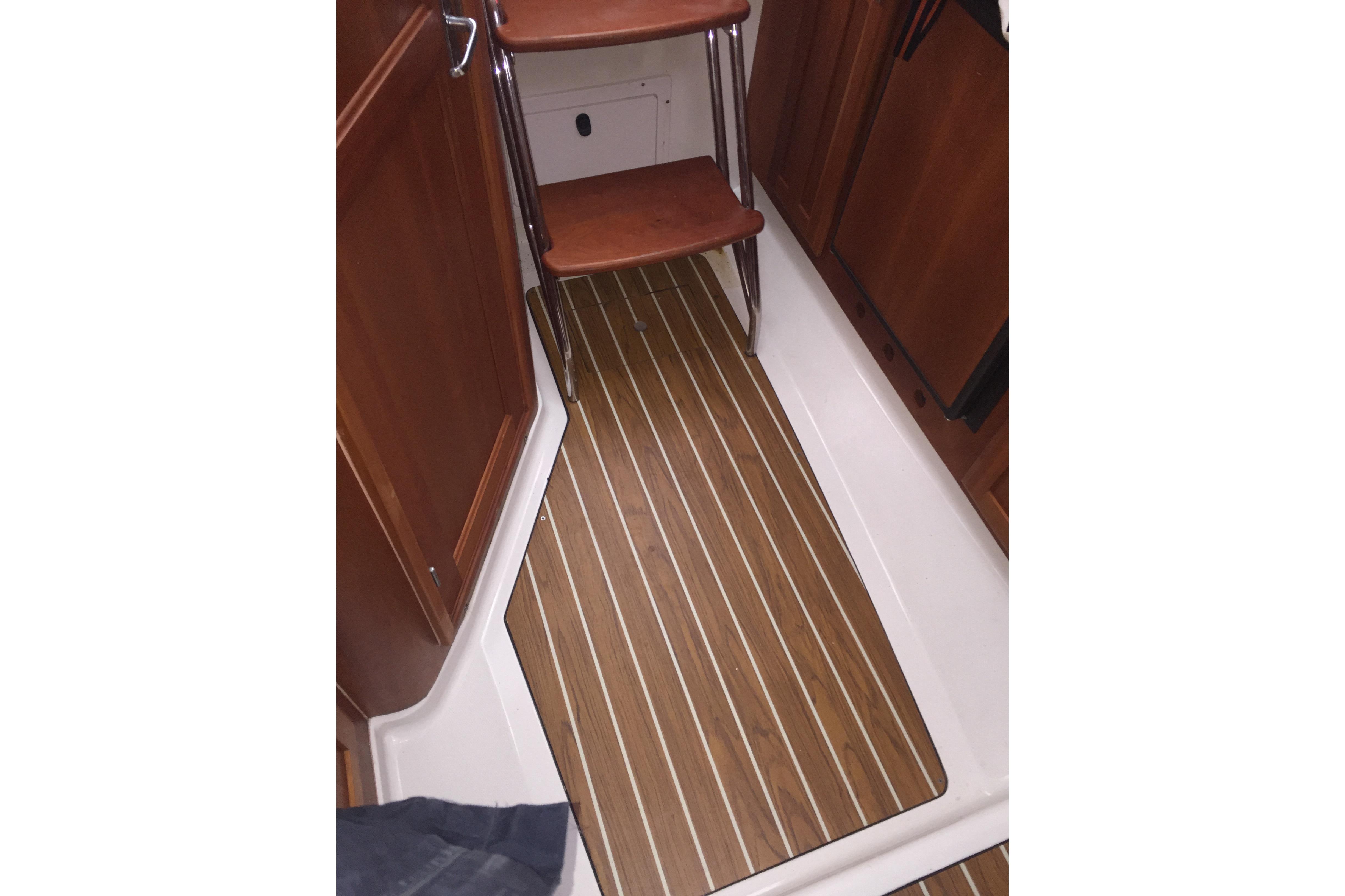2007 Back Cove 29 interior with wooden flooring and steps.