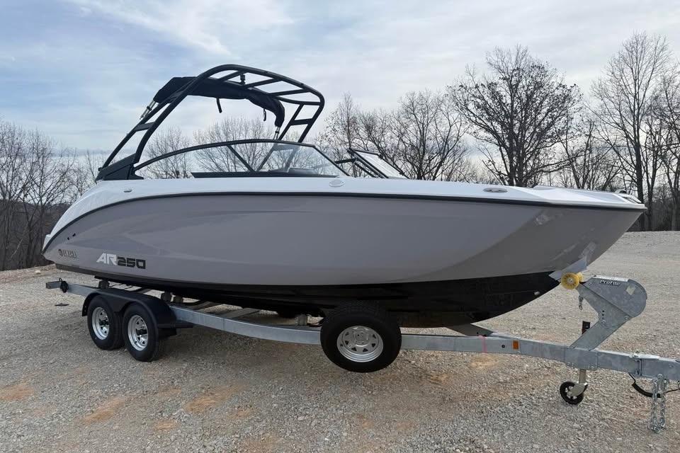 2026 Yamaha Boats AR250 on trailer, parked outdoors, showcasing sleek design.