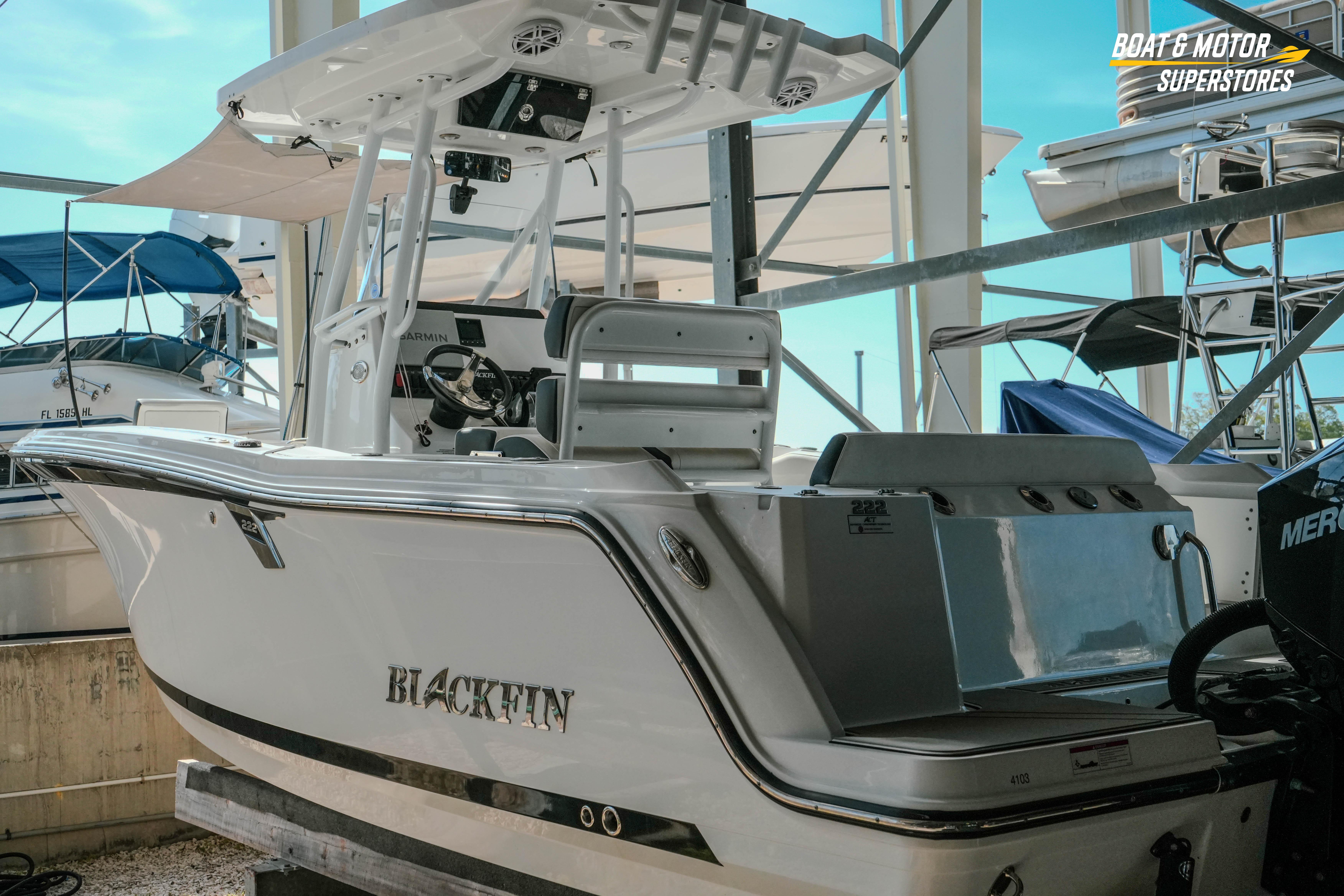 2022 Blackfin 222 CC boat in marina, showcasing sleek design and modern features.
