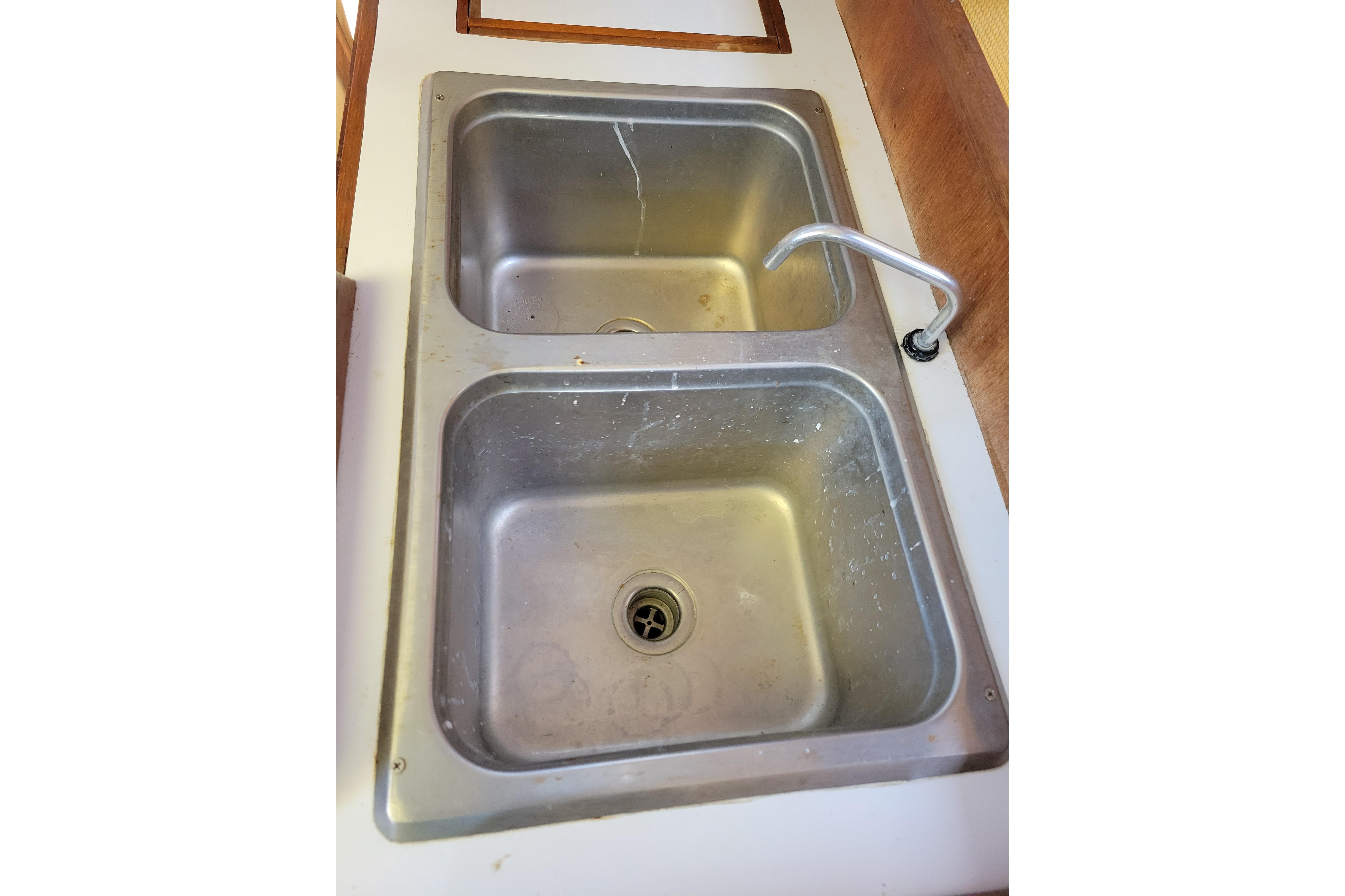 Stainless steel double sink in 1981 Sea Sprite 34 boat galley.