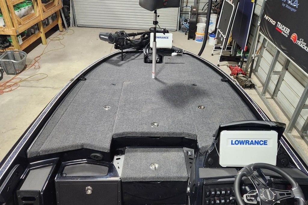 2026 Triton 20XP Patriot boat interior with Lowrance electronics in a garage setting.