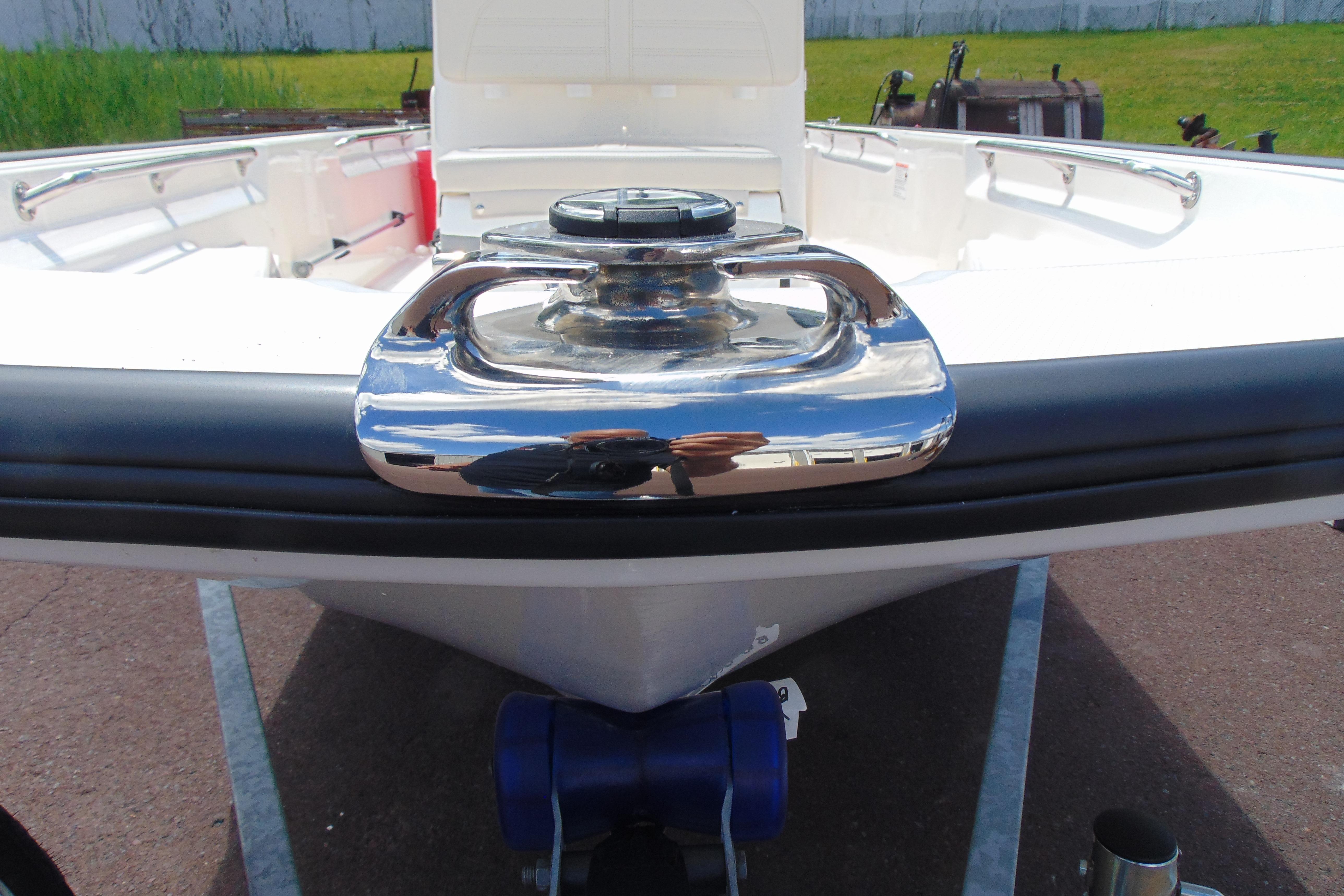 2026 Boston Whaler 150 Montauk boat bow with chrome details and trailer.
