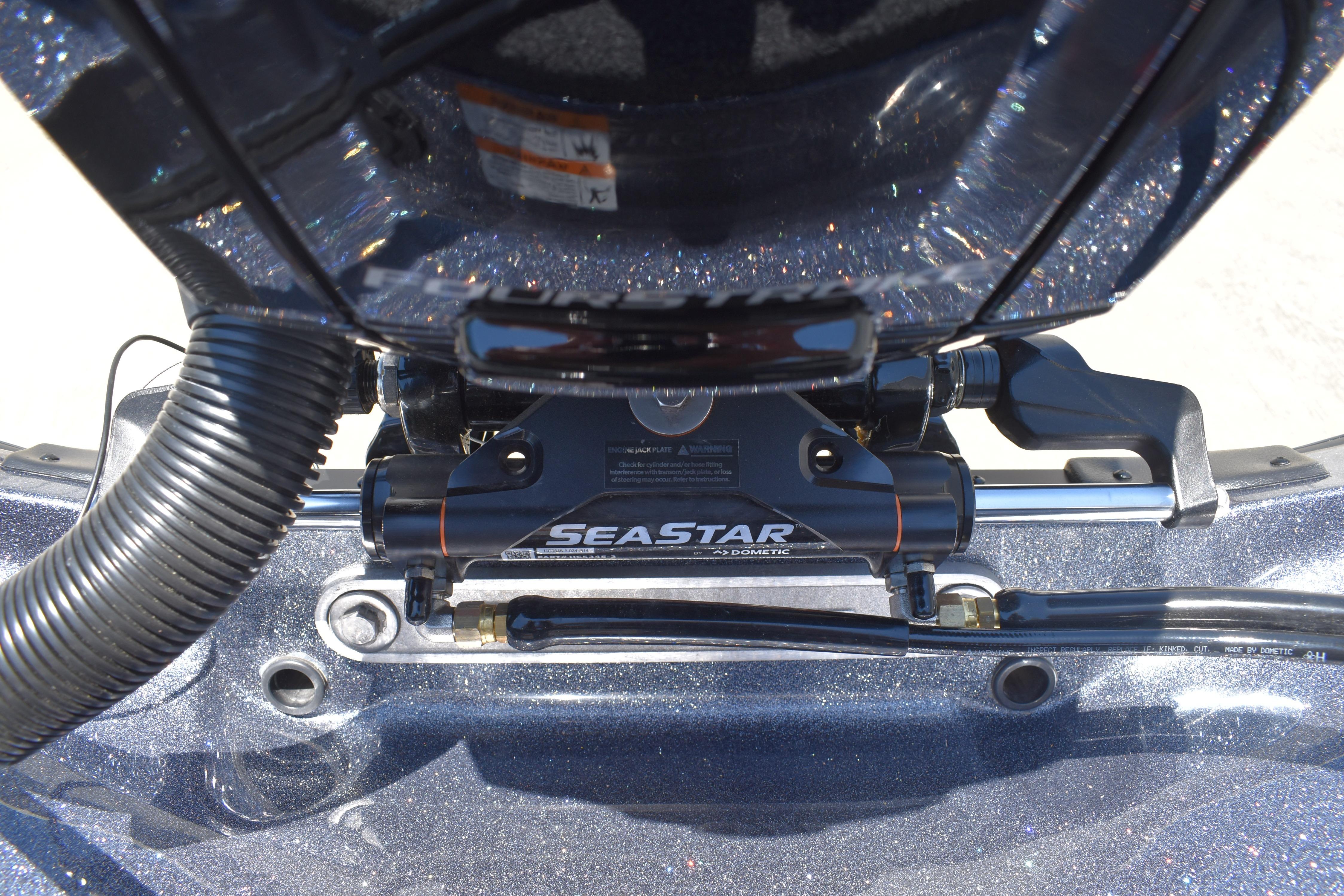 Close-up of SeaStar hydraulic steering system on 2026 Triton 179 TrX boat.