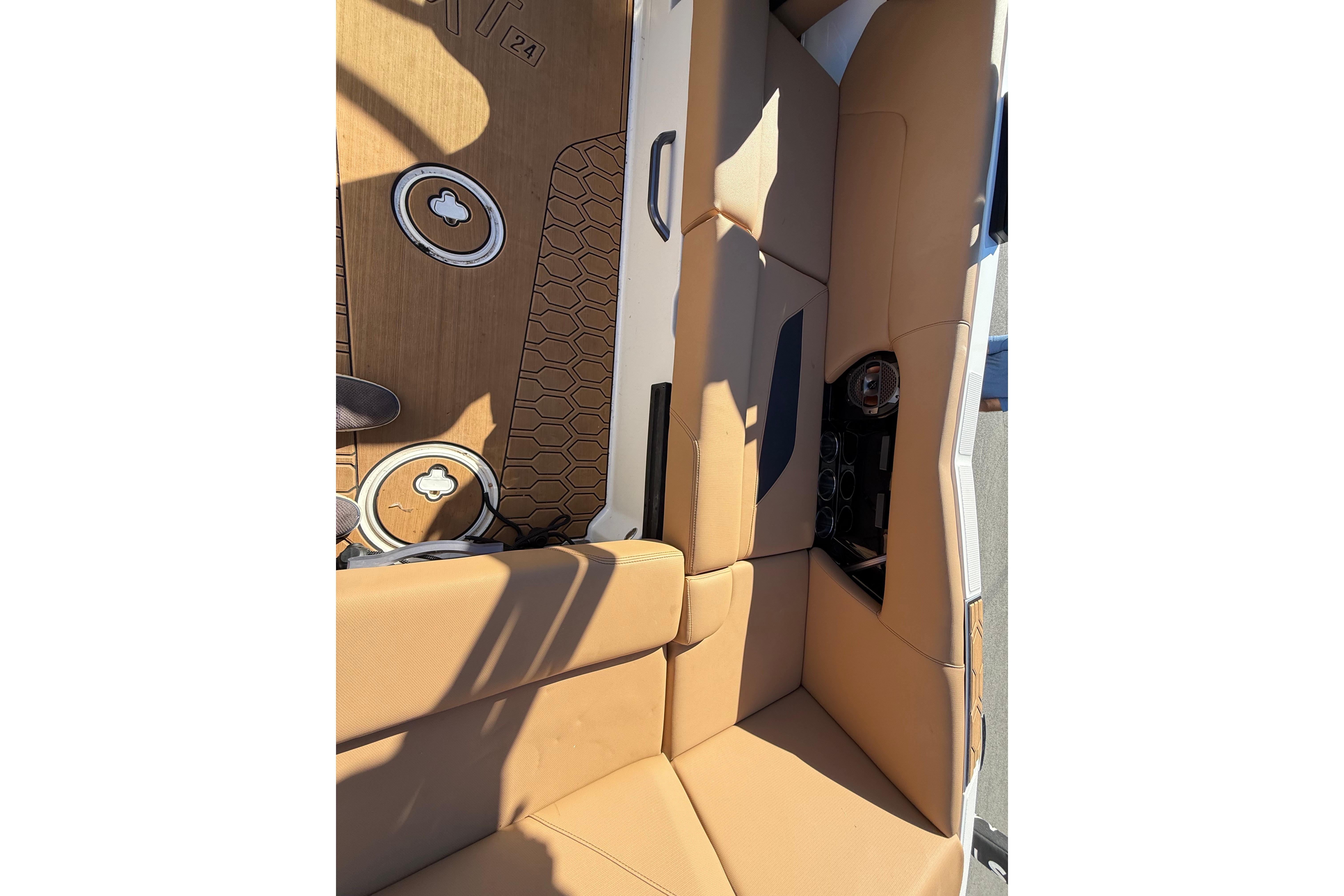 2022 MasterCraft NXT24 interior with tan seating and hexagonal floor design.