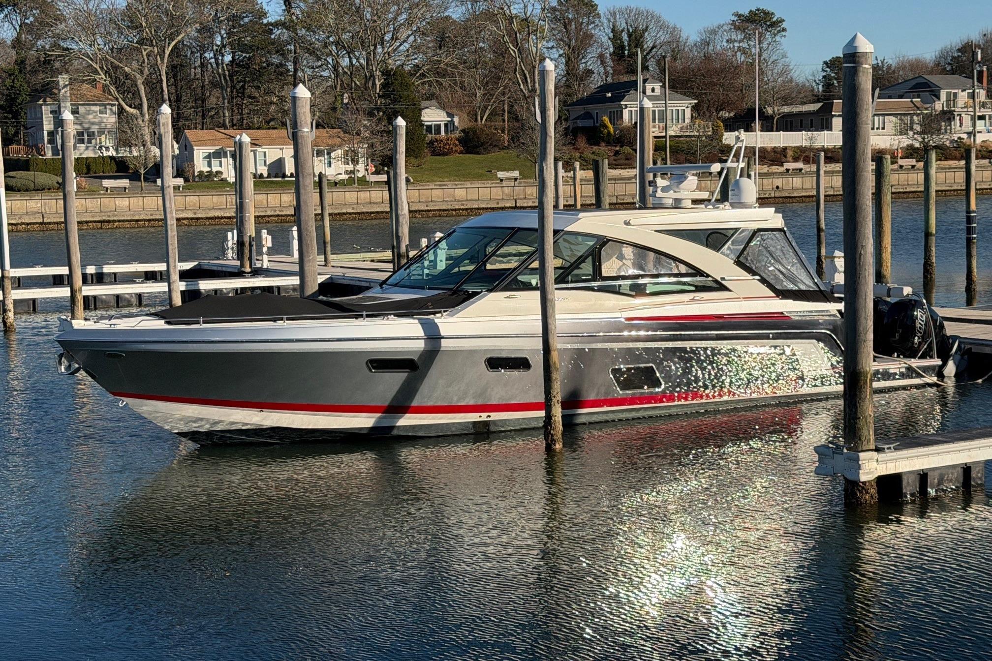 2017 Formula 430 Super Sport Crossover docked in a serene marina setting.