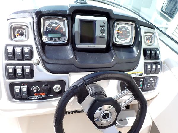 Dashboard of 2011 Chaparral 287 SSX boat with steering wheel and control gauges.
