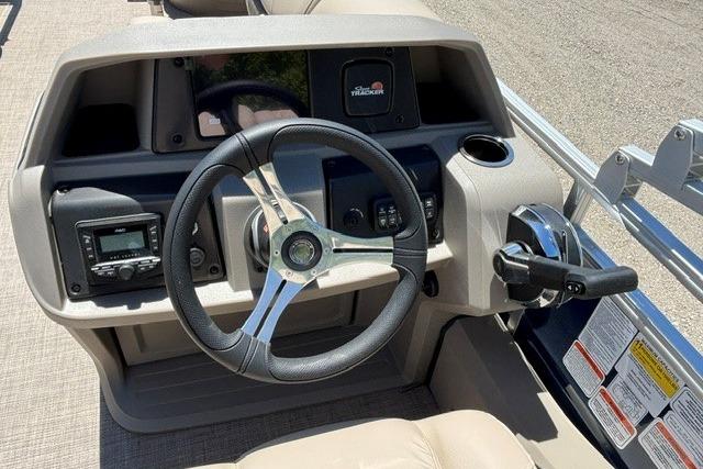 2025 Sun Tracker Fishin' Barge 22 DLX dashboard with steering wheel and controls.