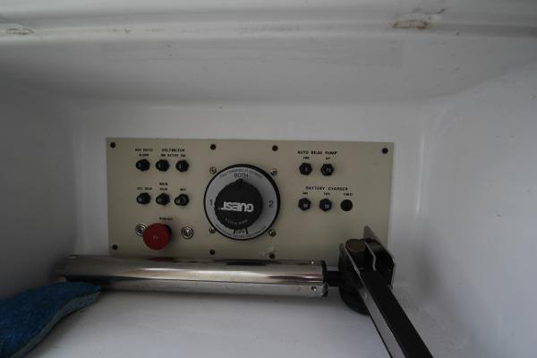 A control panel with various switches and a large dial.