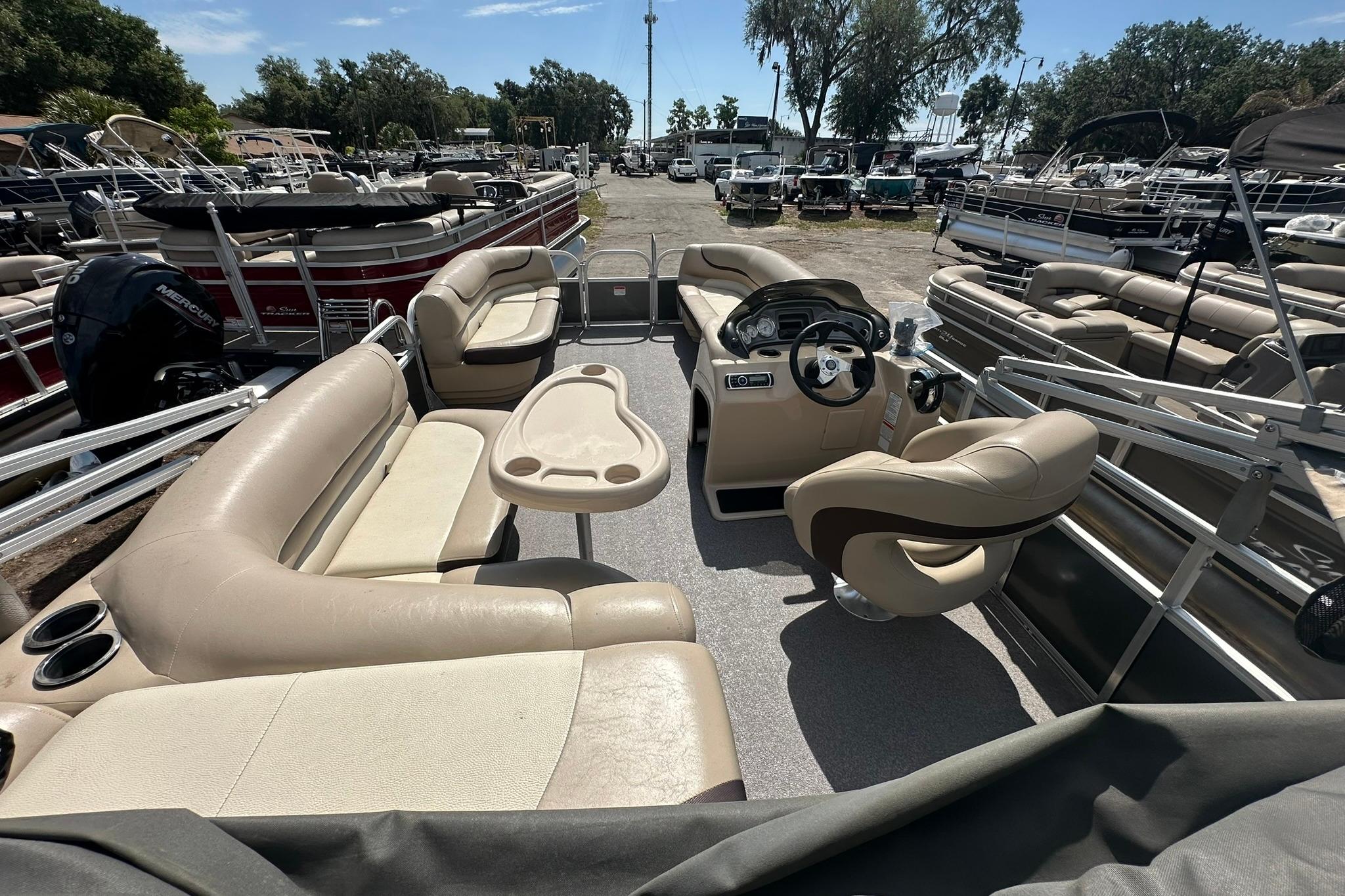2016 SUNTRACKER Party Barge 20 pontoon boat with spacious seating and modern helm.