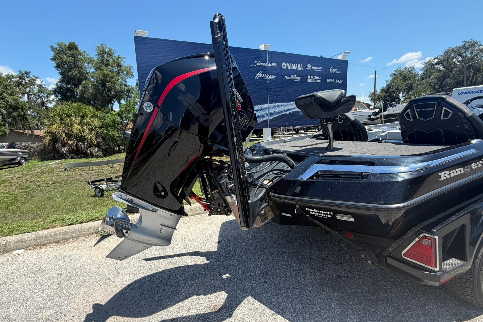 2023 Ranger Z521R boat with powerful outboard motor, parked outdoors on a sunny day.