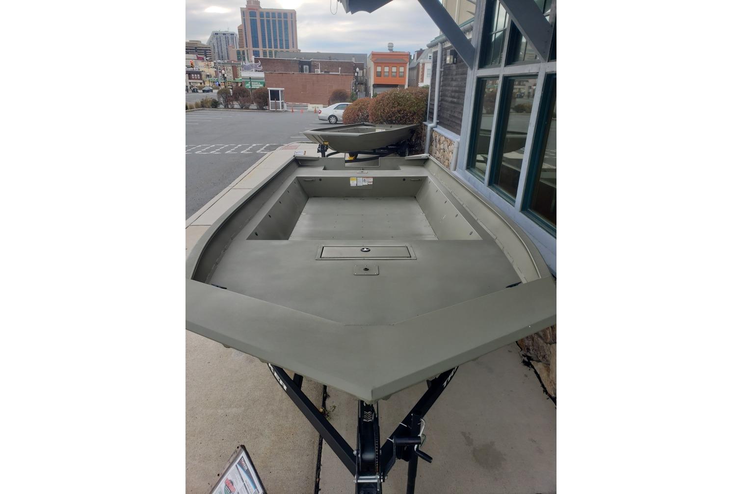 2025 Tracker Grizzly 2072 Utility boat displayed outdoors, showcasing spacious interior design.