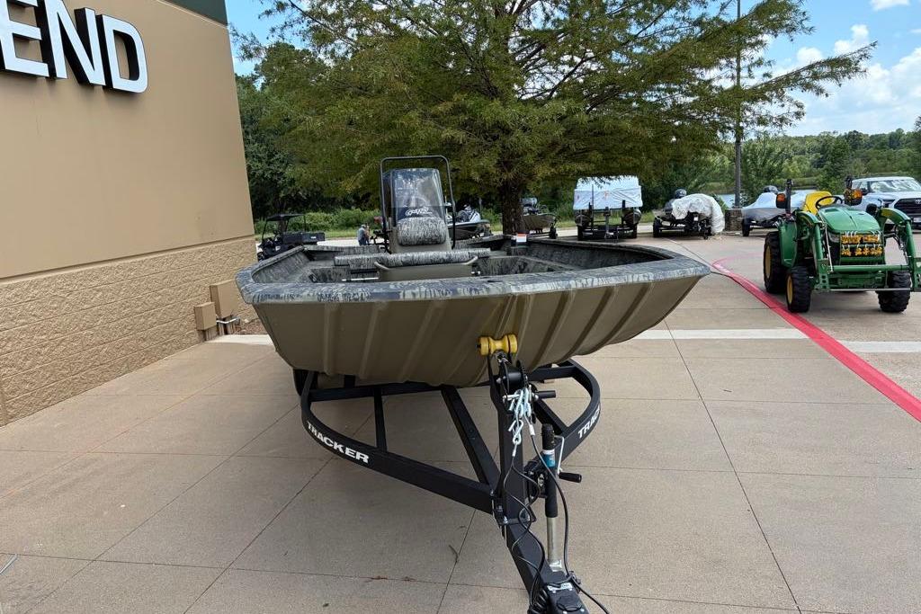 2026 Tracker Grizzly 2072 CC boat on trailer, displayed outdoors near a building.