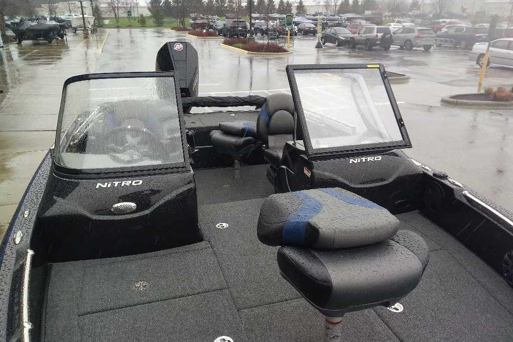 2026 Nitro ZV19 Sport Pro boat in rainy parking lot, showcasing sleek design and seating.